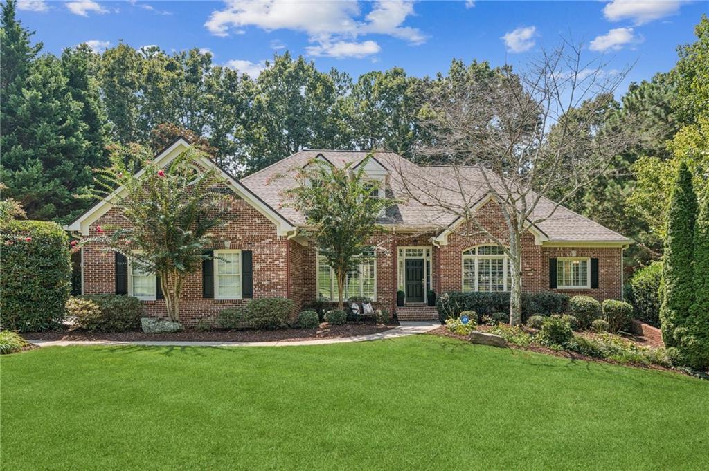 Discover this stunning lakefront ranch in the serene Birmingham Manor, a peaceful Alpharetta enclave with Cherokee County taxes. Meticulously maintained, this home offers tranquil lake views, ideal for kayaking, canoeing, or fishing. Highlights include a beautifully renovated kitchen featuring quartz countertops, Italian tile backsplash, and stainless steel appliances. The home also boasts refinished hardwood floors, fresh interior and exterior paint, plantation shutters, a 2017 roof, and updated HVAC systems (2018), and newer water heater (2019 ). Primary bedroom with lake view on main level with 2 other generous sized bedrooms on the other side of the home. Upstairs is another spacious bedroom with an ensuite bathroom. Residence sits on over an acre lot. The professionally landscaped, fenced backyard includes a fire-pit, a concrete path, and a freshly painted deck with a retractable awning. A spacious unfinished basement awaits your personal touch. Located in the top-rated Creekview High School district, this home feels like a rural retreat yet is close to modern amenities. Enjoy low HOA fees and optional memberships for swim, tennis, or golf at the nearby Woodmont Country Club. Your dream lakeside escape awaits!