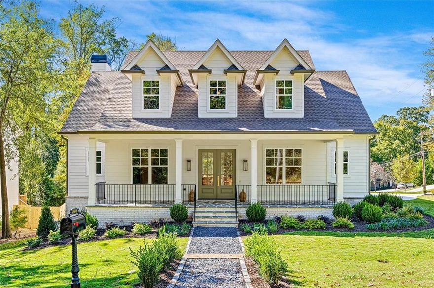 Situated on a prime corner lot in Ashford Park, this newly built 5-bedroom, 4-bath modern farmhouse includes a 3-car garage and unfinished basement for future expansion. The wide flagstone front porch and double French doors open to a bright foyer with detailed millwork and hardwood floors. The designer kitchen features custom cabinetry, brass hardware, marble backsplash, and a large island overlooking the dining area filled with natural light. The family room showcases whitewashed brick, a wood-beam mantel, and tongue-and-groove ceiling, with sliding doors to a screened porch complete with a brick fireplace. Upstairs, the primary suite offers a shiplap-accented tray ceiling, marble spa bath with freestanding tub, and walk-in closet. The private backyard provides space to add a pool, all minutes from top schools, shopping, and dining