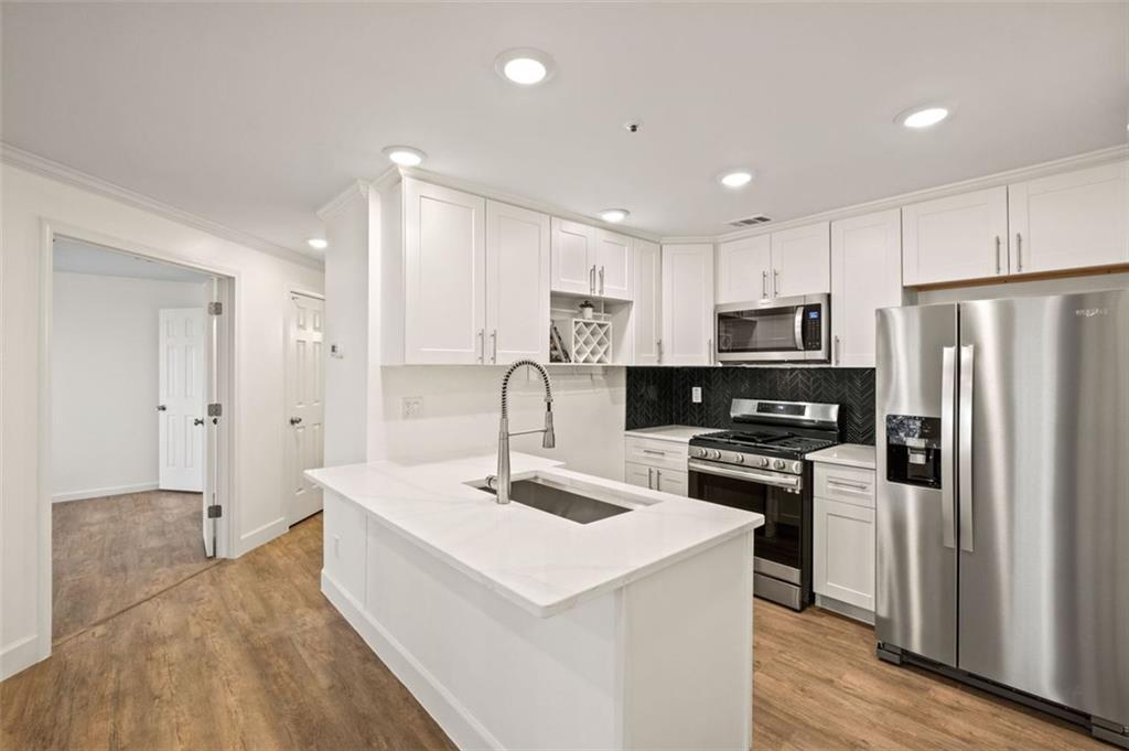 Nature lovers dream! Beautiful FULLY renovated 2 bedroom unit just off Columns Drive in Walton HS district! Short walk to the Chattahoochee river parks walking and biking trail. The condo features an open and spacious layout with a roommate friendly floor plan. Brand new everything from white shaker style kitchen cabinets, quartz countertops, new stainless steel appliances overlooking the cozy living room with a fireplace. Enjoy your morning coffee overlooking the beautiful wooded scenery. Both bedrooms boast walk-in closets, and the bathrooms feature modern, frameless standing showers.. Laundry room with full size washer and dryer included. The Overlook community offers an inviting pool area, all just minutes away from shopping, dining and all that East Cobb has to offer. Great location close to everything and award winning schools.