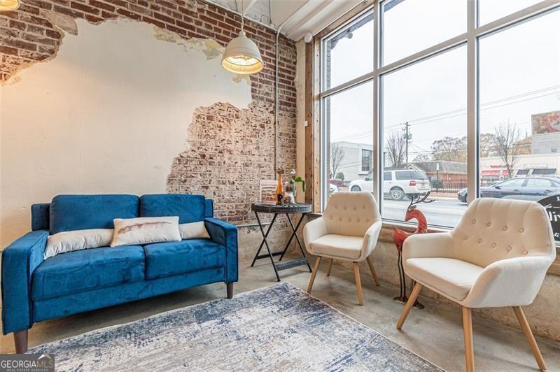 Prime location in downtown Hapeville with high foot traffic and drive by visibility. Building & additional lot sold together with on-street parking and nearby free public lots. Backs up to Arts Alley where many city events held. 2021 Interior & systems full reno, new aluminum front & rear storefront windows & doors, and new oversized deck. Bright open space w exposed rafters, exposed brick, skylight, accessible unisex restroom, accessible front entry, kitchenette, Artwork rail system. End of row-style storefronts. Perfect for grab & go prepared meals, intimate gatherings, office, retail, art gallery/studio, grooming, etc. zoned Urban Village. Sale includes 2 parcels = 2 tax IDs. Do not disturb tenants. Owner holds GARElicense #242305