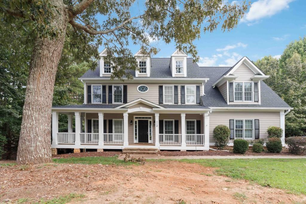Welcome to Creekside Estates, a picturesque community in the heart of Cherokee County where charm, space, and convenience meet. This beautiful 5-bedroom, 3-bath home offers exceptional living with thoughtful design features throughout. Begin your mornings on the inviting rocking chair front porch, then step inside to discover a spacious layout ideal for both entertaining and everyday living. The main level includes a formal living room, a separate dining room, and a family room with a cozy gas fireplace. The kitchen is a chef's dream, complete with stained cabinetry, a double oven, breakfast bar, and ample counter space. Perfect for hosting, the main floor also includes a guest bedroom and full bath. Upstairs, the primary suite features a large en suite bath, dual vanities, and generously sized walk-in closets. Additional bedrooms are roomy and versatile, and built-in shelving adds charm and functionality. Need more space? The full unfinished basement offers endless potential for a home gym, media room, workshop, or additional living area. Enjoy nature and recreation just minutes away waterfall, Veterans Park, and other local favorites are just around the corner.