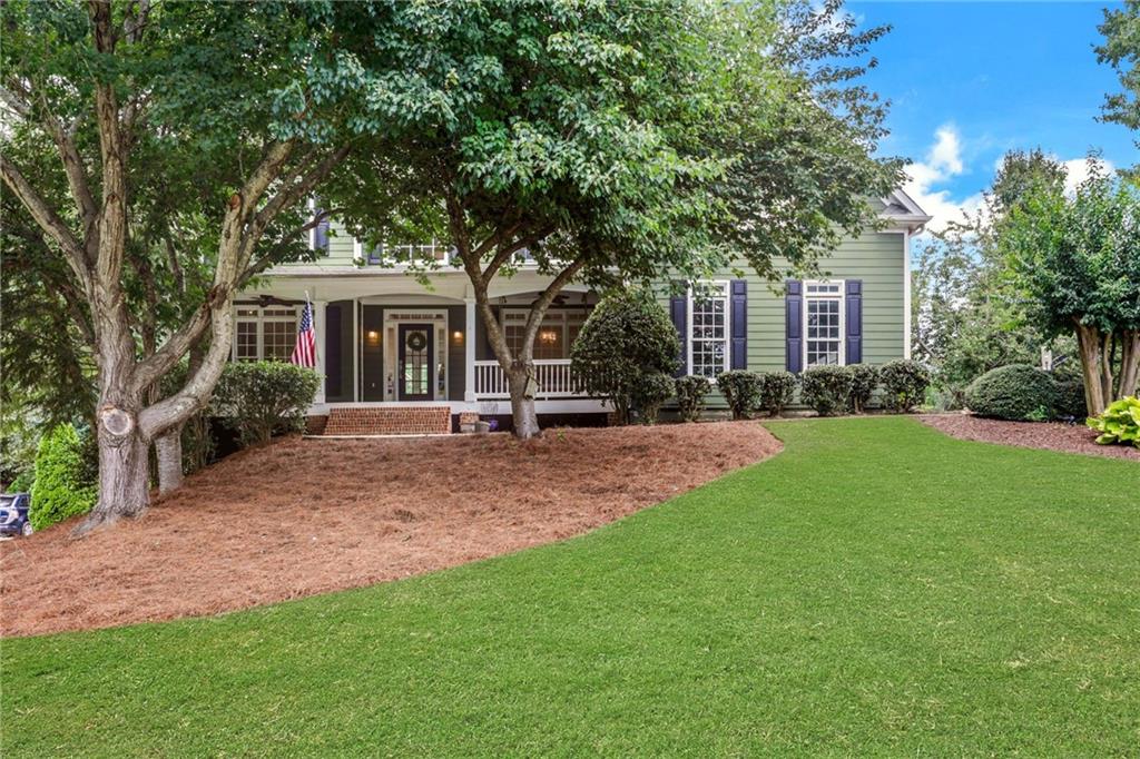 Welcome to this stunning Modern Farmhouse, perfectly positioned on a quiet cul-de-sac in the sought-after Woodland Park swim/tennis
community. From the moment you arrive, the extended front porch invites you in — ideal for relaxing with a morning coffee or hanging
that dream porch swing. Inside, you'll love the bright, open floor plan, expanded two feet across the back of the home for a spacious
kitchen and family room area. The updated kitchen features crisp white cabinetry, gorgeous new quartz countertops, and flows seamlessly
into the family room with beautiful wood floors throughout the main level. A private home office with French doors and a formal dining
room offer the flexibility today's buyers want. Upstairs, the owner’s suite includes a versatile sitting room — perfect for a home office,
fitness space, or quiet retreat — along with three generously sized secondary bedrooms, each with its own bath. The finished terrace level
is built for entertaining, complete with a custom bar, media and game areas, a guest bedroom, and a full bath. Outdoor living is a highlight
with two screened porches, a huge extended deck, and a large, fenced backyard. A three-car side entry garage adds convenience. Located just
one mile from GA 400 and The Collection, with easy access to Halcyon and Downtown Alpharetta, this home also sits within one of Forsyth
County’s top-rated school districts. Updated, spacious, and in a prime location — this home has it all.
