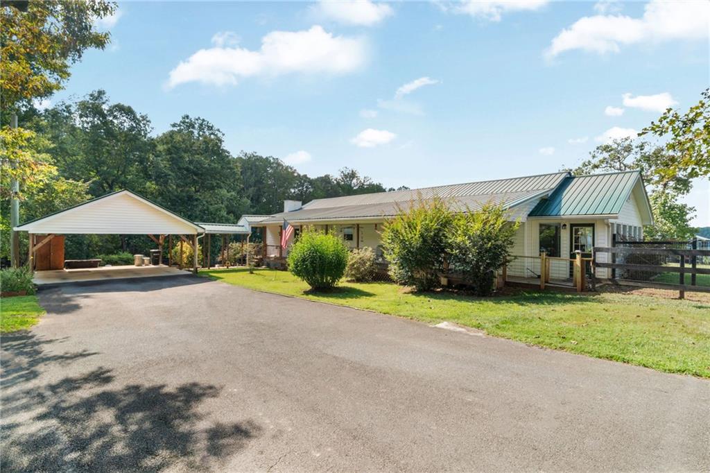 For equestrians who’ve been waiting on the one—this 10-acre farm in Jasper is a true move-in-ready horse property wrapped in old-homesite charm. Set on a corner lot with frontage on Bryant Road and Watson Lake, the land itself is the heart of the story: ~6.5 acres of cross-fenced pasture already prepped for livestock, shaded by century-old oaks and catalpa trees, with a seasonal stream at the back and private access to an 18-acre shared lake stocked with bass, crappie, and catfish.
The fully restored 1942 farmhouse blends history with modern comfort. Original hardwood floors were brought back to life, complemented by new LVP flooring in the living spaces. The remodeled kitchen features custom cabinetry, dual pantries, hidden lazy Susans, and newer appliances. With three bedrooms, two baths, and a versatile bonus room that can flex as an office, gym, or fourth bedroom, there’s space for both family and farm life. Outside, a large covered porch, two sunrooms, and a firepit create gathering places for every season.
Horse amenities shine here: a six-stall barn fully rehabbed inside and out, with custom pine-and-iron fronts, matted stalls, exterior Dutch doors, tack room, water, upgraded 200-amp power, fans, cross ties, and loft space for hay or storage. Double sliding doors allow easy airflow and security, while the ~50’ round pen sits just outside. The property also includes a two-story storage shed with lean-to, a double carport, three yard hydrants, and secure fencing (no direct pasture access from public roads).
Every thoughtful improvement has already been made—tree clearing, overseeded pastures, new fencing and gates, new AC and water heater, brand new septic, metal ductwork, and foam insulation—so you can simply step into the lifestyle. Bonfires in the backyard, dogs running free, horses grazing in rolling fields, sunsets over the water—this is where farm life meets everyday comfort, without the “project” list.
**Contact the listing agent for this property's website. Here you will have access to VIDEO TOURS of the property, an extensive features and upgrades list, as well as property disclosures.