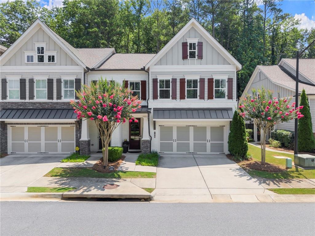 Welcome to your dream home in the perfect location—conveniently nestled just off Hwy 92, minutes from both downtown Roswell and downtown Woodstock. This stunning 3-bedroom, 2.5-bath end-unit townhome feels nearly custom with its high-end finishes, open-concept design, and abundant natural light throughout. Step inside to find engineered hardwood floors flowing through the main level, and a panoramic sliding door opening to your private patio—perfect for seamless indoor-outdoor entertaining. The spacious kitchen boasts an oversized island, gas stove, generous cabinetry, and a custom walk-in pantry. A thoughtful mudroom area just off the garage keeps things tidy, while the oversized laundry room offers built-in cabinetry and a sink. Every bedroom features custom closet systems, and the oversized primary suite includes a bonus sitting area or office space. The spa-like primary bathroom offers a double vanity, soaking tub, and a large tiled shower with a waterfall shower head.
Additional highlights include:
– Elevator shaft ready for future installation
– End-unit location with extra windows and natural light
– Ample storage and designer details throughout
Enjoy community amenities including a dog park, walking trails, firepit, and a covered gazebo with a grill station—ideal for gathering with friends and neighbors. This home blends luxury, convenience, and lifestyle—schedule your tour today and fall in love!