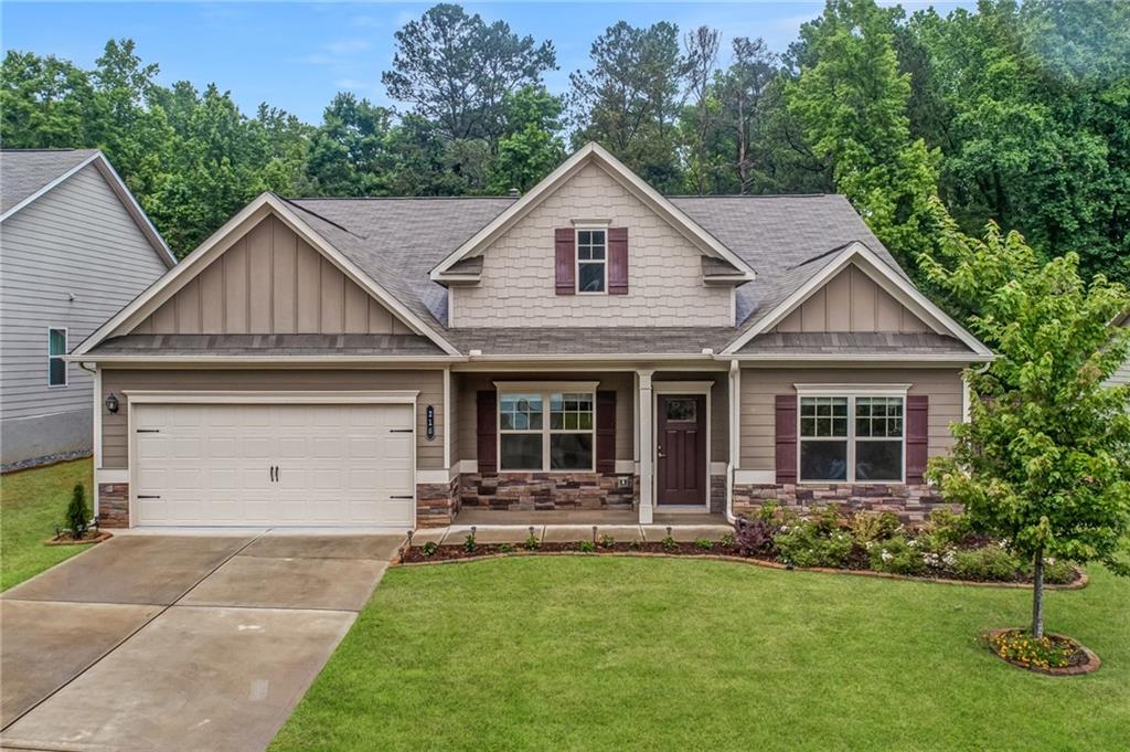 Beautiful, almost new home in quiet neighborhood in Sequoyah High School district. Featuring one level living, this 3 bedroom, 3 bathroom home will take your breath away! Enter the front door and get greeted by high ceilings, beautiful LVP flooring, and dramatic trim work. Two private bedrooms with their own bathrooms accentuate the front of the home. The kitchen features 42" stained cabinets, granite counters and stainless appliances. The kitchen boasts an oversized island with seating for 6 overlooking the family room. The open concept floorplan boasts a dining room with seating for 12+, a breakfast room off the kitchen, and a large family room perfect for entertaining. The private, oversized master suite comes complete with a tray ceiling, ensuite bathroom, and a large walk-in closet. The backyard is an entertainer’s dream. Located on one of the largest, flattest lots in the neighborhood, the backyard features a large, screened porch accentuated by a large stone patio and expertly landscaped flowerbeds. Minutes from The Outlet Shoppes at Atlanta, dining, and entertainment, this home is one you won’t want to miss!