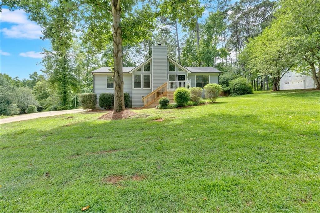 JUST LISTED! Completely updated inside with the BEST floorplan and ALL NEW INTERIOR PAINT. As soon as you see the HUGE family room with the soaring ceiling, you will know this IS THE ONE! Floor to ceiling stone fireplace with two story windows on each side capture all the natural sunlight. High quality LVP runs through out the house (not the cheap stuff) Updated kitchen has TWO built in pantry's, recessed refrigerator that stays, professionally painted (real wood) cabinetry, black SS appliances w/5 burner gas stove & views to the family room. Separate dining room with large windows that over look your fenced backyard. Split floor plan with oversized primary suite on the opposite side of secondary bedrooms. All bedrooms have walk in closets. Both bathrooms have been updated with granite counters. There is extra trim and details through out the house. Roof was replaced with 30year shingles in 2020 and new 6" gutters with gutter guards installed at the same time. Insulated garage doors replaced & has remote access garage door openers , pull down attic stairs and the attic insulation is top notch, so this house stays very comfortable without breaking the bank. Privacy fence in backyard PLUS there is an invisible fence that runs the perimeter of the entire yard. The side yard is perfect for parking your toys and less than 1 mile to the boat ramp at Lake Allatoona! Let's talk about the garage and terrace level. You can fit 5 cars down there or finish off the back part and have more finished space if you need it. Big trucks, boats and toys all fit! You can't beat this location, NO HOA and minutes to dining, shopping and Hwy's. All for under $400,000!