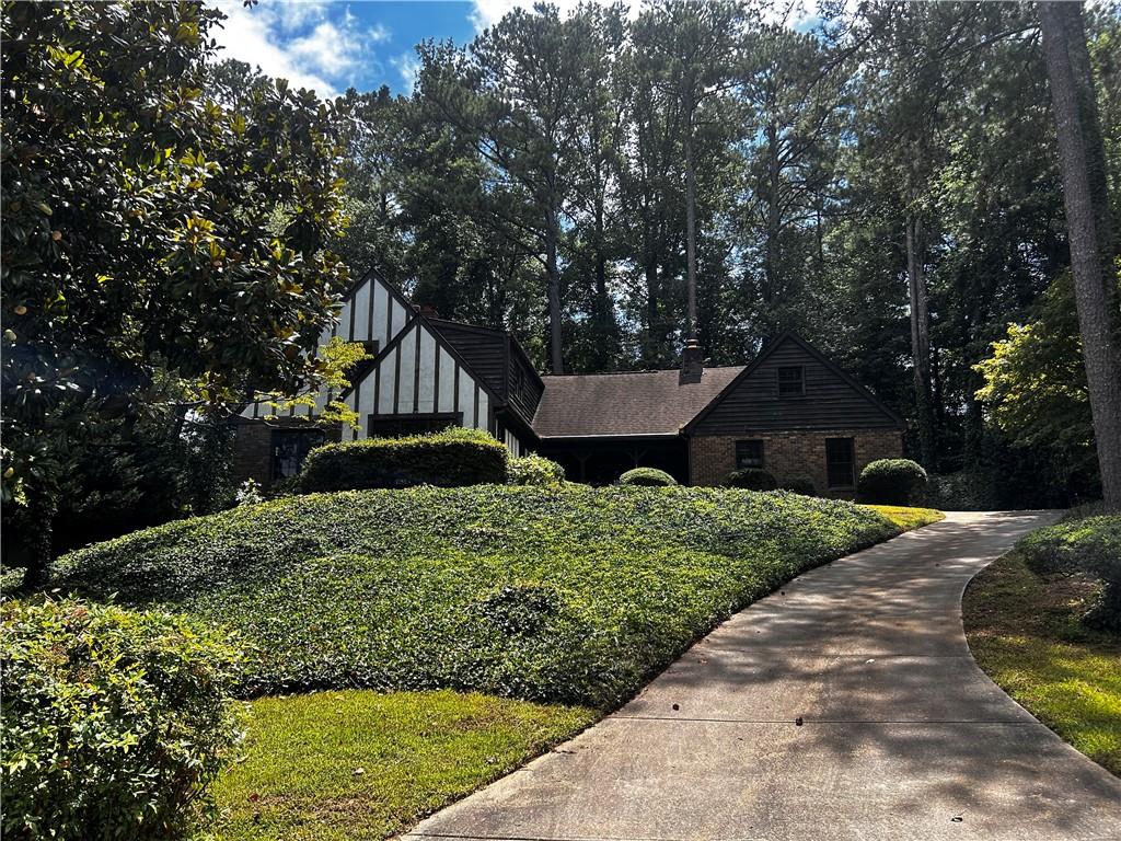 Welcome to 285 Old College Way NE, a charming Sandy Springs home with a spacious layout and plenty of room. Tucked back from the street, the property features a long driveway and side carport, offering both privacy and convenience. Inside, you’ll find an easy-flow floor plan with generously sized living areas that are ready for your personal touch. This home presents an excellent opportunity to create the style you’ve been envisioning. The basement level is a great bonus, complete with a recently bathroom and kitchenette—perfect for additional living space. With character, space, and potential in an ideal location, this property is ready to be reimagined into something special. Ideally located near shopping, dining, and major highways, this home combines character, space, and potential in a prime Sandy Springs location.