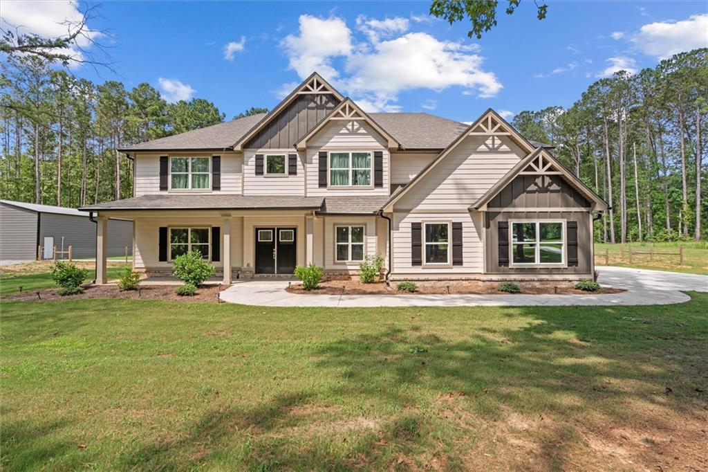 Experience the perfect blend of contemporary elegance and laid-back rural charm in this beautifully crafted 2023 like-new home, thoughtfully positioned on 5.91 acres of serene countryside. As you enter the home, you're greeted by a 2-story foyer with natural light filling the open-concept interior with high ceilings. Multiple patios off the main level invite effortless indoor-outdoor enjoyment and serene moments surrounded by nature. Tasteful upgrades elevate every space of the interior including a stylish accent wall in the separate dining room, sleek stone countertops, durable LVP flooring, and a spacious eat-in kitchen featuring a large island and breakfast area. This home offers 5 bedrooms, 3.5 bathrooms, and a multi-use loft that expands your options for a home office, game room, or bonus entertainment space. The main-level primary suite is a true retreat featuring a spa-like ensuite with a double vanity, soaking tub, tiled shower, and an oversized owner's closet.
The exterior is equally impressive. A fully fenced landscape provides privacy and flexibility for pets or small livestock, while the impressive 46'x50' powered workshop -- featuring spray foam insulation and a separate circular drive -- serves as a dream space for storage or hobbies. Recent enhancements include upgraded French drains for efficient water flow, gutter guards for maintenance ease, two additional patio spaces, a paved walkway to the shop, and the transformation of the original patio into a screened porch for entertaining. This property offers the tranquility of country living without compromising sophistication, comfort, or functionality. The current owners poured their heart and soul into making this their dream home, but life's next chapter has led them out of the area, opening the door for someone new to enjoy this exceptional haven!