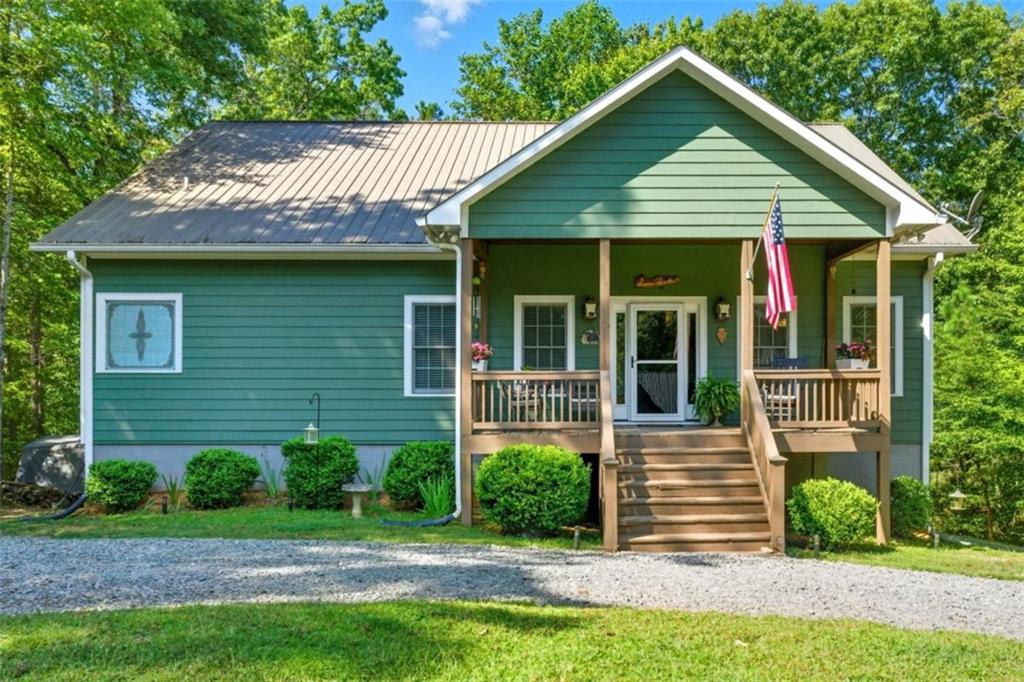 Welcome to 144 Monet, where charm and comfort come together in the heart of the North Georgia foothills, in Coosawattee River Resort. From the moment you step onto the wide rocking-chair front porch, this home feels like a warm embrace. Inside, sunlight pours through the windows, reflecting off gleaming hardwood floors. The foyer opens into a bright dining room, while the heart of the home is a spacious kitchen with granite counters, rich cabinetry, and a breakfast bar that overlooks the cozy fireside family room -perfect for gathering with loved ones. The main-level primary suite is a peaceful retreat with a tray ceiling, room to relax, and a spa-like bath featuring dual vanities, a soaking tub, and a separate shower. A versatile flex room with French doors can be your office, craft space, or quiet reading nook-whatever suits your lifestyle. Downstairs, the terrace level transforms into a private living quarter of its own, complete with a fireside den, two bedrooms, full bath, a kitchenette and its own entrance and driveway. It's the perfect setup for in-laws, guests, or even multigenerational living. Step outside to enjoy nature at its finest-sip coffee on the screened porch surrounded by nature, or park your RV with ease knowing there's space for it here. 144 Monet isn't just a house-it's a haven, designed for gathering, relaxing, and living fully.