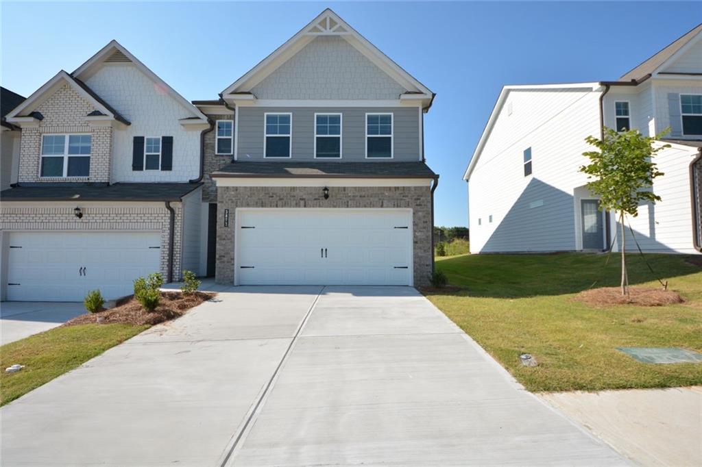 A new end-unit townhome with lots of upgrades. Brick front, two-story, 2-car garage. Upgrades include quartz countertops in the kitchen and bathrooms, pendant lighting in the kitchen, etc. Additional windows in the living and 2nd-floor loft provide lots of sunlight. The Cole C plan features 1949 square feet with three bedrooms and two bathrooms upstairs and a powder room downstairs. SPC floor on main. The kitchen features 42" shaker-style cabinetry, SS appliances, and a pantry with wired shelving. Master suite with tray ceiling, walk-in closet, and ceramic tile bathrooms. Spacious secondary bedrooms with ample closet space to enjoy. Tile floors in all bathrooms and the laundry. Window blinds will be installed. Refrigerator/washer/dryer is included, although the photos don't show it. Close to downtown Gainesville, Lake Lanier, and many dining and entertainment areas. $500 discount on the 1st month's rent if you move in before October 1 with a two-year lease.