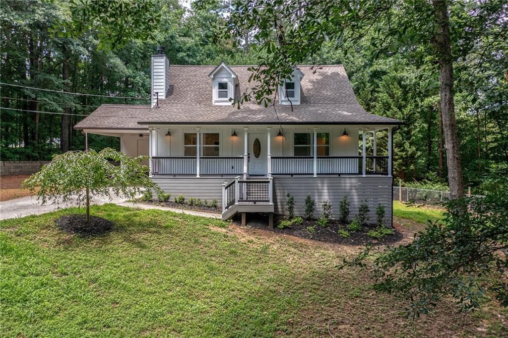 Welcome to the FULLY RENOVATED home of your HGTV dreams on a large, lush, and private lot in sought-after Dallas location on Pine Shadows Road. This completely renovated farmhouse-inspired oasis has a picturesque winding driveway and sits atop a rolling green hill overlooking the year-round creek valley. As you pull up to the home, you'll immediately fall in love with the front porch where you can sit in total privacy on your rocking chair and listen to the babbling creek below. This estate also boasts a personal vineyard, a myriad of fruit trees, a vegetable garden, and large barn complete with hatchery and extensive outdoor irrigation system. To compliment all the upgraded features and finishes, the full renovation is complete with a new hot water heater, HVAC, hardy plank siding, and a 2-year old roof! Luxury flooring installed throughout the main level, woodplank-style tile bathroom flooring, showers and backsplash. Professionally designed kitchen and master bedroom/bathroom on the main. New graphite designer color SS appliances including brand new washer and dryer. Custom cabinetry, pocket doors, shiplap feature walls, farmhouse sink, recessed lighting, wood burning fireplace, stain resistant carpeting upstairs, and granite countertops throughout! This happy home even has an oversized screened-in back porch with custom all knotty pine tongue & groove walls and ceiling, with a 6-person hot tub overlooking the dreamy fenced backyard. Conveniently close to shopping, restaurants and in award-winning Paulding county School District.