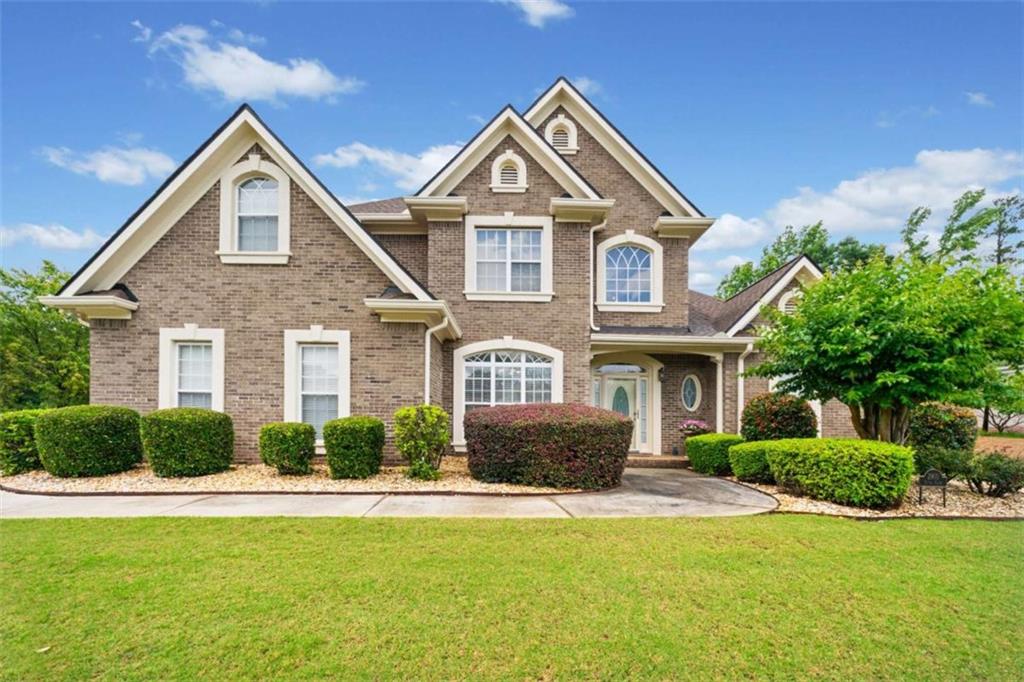 Located in the well sought after St Remy community, this four-sided brick home with circular driveway is just what you are looking for! The manicured landscaping and meticulously maintained lots throughout the neighborhood create a picturesque and serene environment. The open floor plan seamlessly flows between the living areas, allowing for comfortable everyday living and effortless hosting. This home features four spacious bedrooms, two and a half baths, with the owner's suite situated on the main level. Upon entry you will find a separate formal dining room and half bath on your path to the two-story family room. With ample size the family room sits right off the kitchen with it open floor plan, featuring the keeping room, eat-in area, counter height bar top, two pantry closets, granite counter tops, stainless steel appliances, hardwood floors, and the laundry room. Also located on the main level of the home is the owner's suite featuring a lovely sitting area and en-suite that has separate shower, jetted tub, and double vanities. You can also step out to the manicured lawn and patio area on this level of the property. Upstairs you will find three generously sized secondary bedrooms that offer flexibility in accommodating guests or providing dedicated home office or hobby spaces. The secondary bedrooms are accompanied with a full Jack and Jill style bathroom. This swim/tennis community provides opportunities for recreation, leisure, and socializing. The combination of the home's features, proximity to expressways, shopping, and restaurants all make this property an appealing choice.