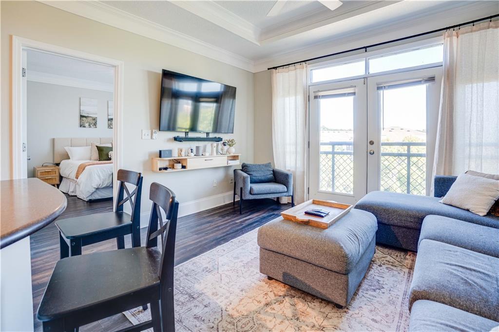 Modern top-floor 2 bed, 2 bath roommate-style condo in Atlantic Station. Features include a dining room, open kitchen/living area, master suite with double vanity, garden tub, separate shower, and walk-in closet. Second bedroom is separated by a hall with laundry and a full bath. Updated water resistant laminate flooring in the main living space. Balcony doors open to view of the park. Perfect for some fresh air on a beautiful day. Walking distance to Atlantic Station shopping, restaurants and entertainment. Easy access to pubic transportation, including the nearby MARTA Arts Center Station. Minutes away from Georgia Tech campus. The Art Foundry community provides resort-style amenities including a pool, fitness center, sauna, and business center. Don't miss this opportunity for modern living and city life at its best.