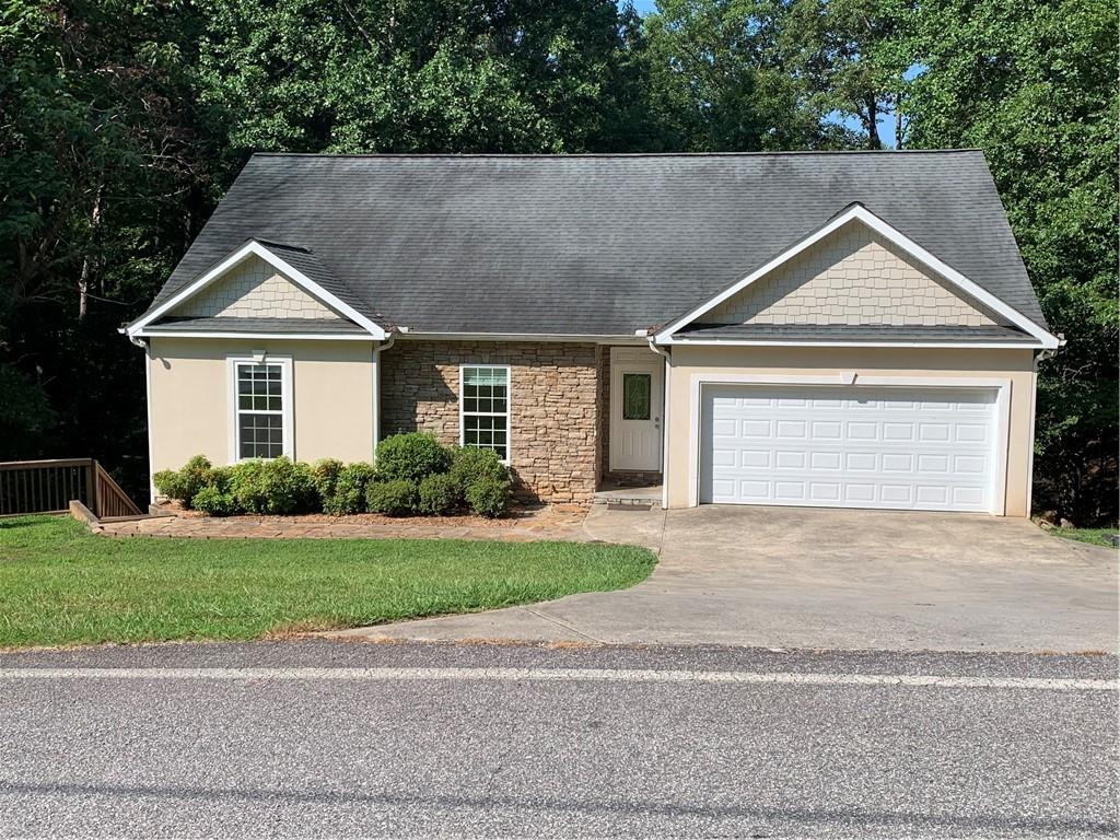 Welcome to 516 Golden Avenue in the ever popular Dahlonega, GA. Perfectly positioned in the rolling foothills of North Georgia, this remodeled four bedroom, three bathroom, roommate plan is more than just a home—it's a gateway to a lifestyle defined by natural beauty, Southern hospitality, and timeless charm. This exceptional property blends classic design elements with modern amenities, offering an idyllic retreat for families, professionals, or anyone seeking to embrace the unique spirit of Dahlonega. What's great about this property: Located on Golden Avenue one of Dahlonega's most sought after areas; minutes to the charming downtown square, the University of North Georgia, local wineries, award winning restaurants, and the hiking trails and reservoir at Lake Zwerner and the Yahoola Creek Reservoir; 10 minutes to GA 400 for access to the Dawsonville Outlet Mall, medical facilities, and other amenities further south in the north metro area; 90 minutes to Atlanta - Far enough to get away from the big city, but close enough when needed; fully finished basement with a second full kitchen, full bathroom, bedroom, and living room; close to tons of outdoor recreation sites for camping, hiking, fishing, river tubing, and taking in the beautiful mountain views; and it has plenty of parking for the basement living area and the top main floor. 516 Golden Avenue offers over one acre of land and 2256 square feet of living space, plus a fully finished basement living area that could be a downstairs apartment or additional living space for a family, makes this home perfect for investors, families, couples, or a single person. This home has great curb appeal and has been meticulously maintained. Two outside decks offer the tranquility of the wooded setting and quiet street for morning coffee, outdoor dining, or just taking in nature. Homes like this don't come along often in Dahlonega, so don't miss this opportunity to own a beautiful home in one of the most sought after towns in North Georgia.