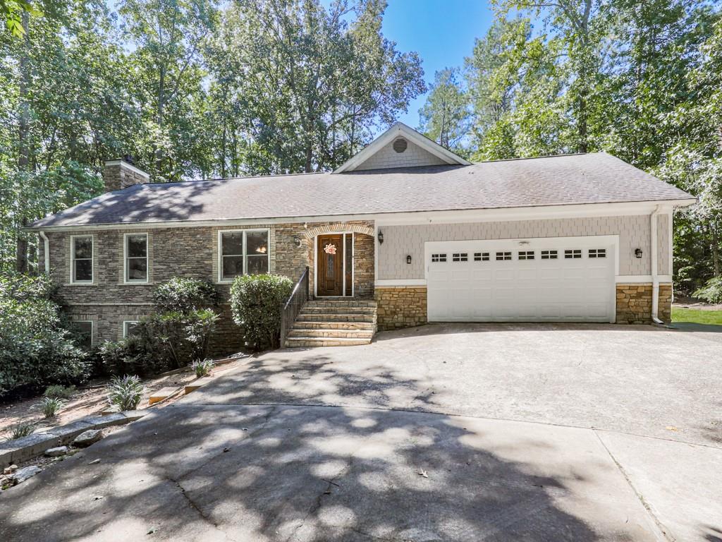 Nestled on over 2 acres of wooded privacy, this solid and inviting home offers the perfect blend of space, charm, and convenience. The open floor plan flows beautifully, starting with a warm and welcoming kitchen featuring solid wood cabinetry, stainless steel appliances, and granite countertops. A huge breakfast/dining room provides plenty of space for gatherings, while the massive family room impresses with its gas log fireplace, soaring vaulted ceilings, and access to a private back deck overlooking the serene setting.
Upstairs, you’ll find a versatile loft/office and a stunning master retreat with its own private balcony. The spa-like en-suite bath features a clawfoot soaking tub, tiled walk-in shower, and double vanity. Two additional spacious bedrooms are located on the main level along with a covered, screened porch perfect for enjoying the outdoors year-round.
The finished basement expands your living options with a large common area, additional bedroom and full bath! Outside, a fenced backyard provides plenty of room to roam, while the long winding driveway crosses a tranquil creek, setting the tone for this peaceful retreat.
Located just seconds from Milton, Alpharetta, and Cumming parks, shopping, and activities, this home is a true showstopper—offering the best of privacy, space, and location.