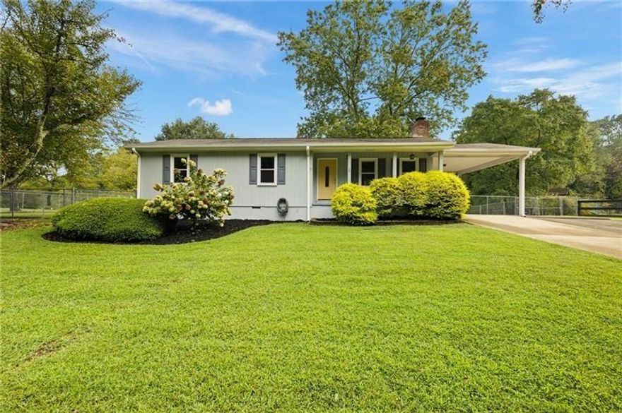 Fantastic Location! Zoned AG1 Bring your animals! This fantastic ranch home has over an acre of land. The backyard is completely fenced. A separate  area on the side yard is enclosed as well. The location is close to shopping and under a 15-minute drive to Halcyon and Avalon! It is truly the best of  both worlds! The entire home has been lovingly updated. Beautiful Kitchen and Baths! Please see the separate upgrade list. Offering 2 outbuildings!  The largest outbuilding offers a 2-door garage entry and has heat and air! There is an RV hook-up in the backyard. There is not an HOA in place for this home/property.  You can live/work/play within your property! Carport good for 2 cars with outside storage room and chicken coop!  Two more cars can park in driveway. Total privacy and quiet street but yet easy access to downtown Milton and Alpharetta!