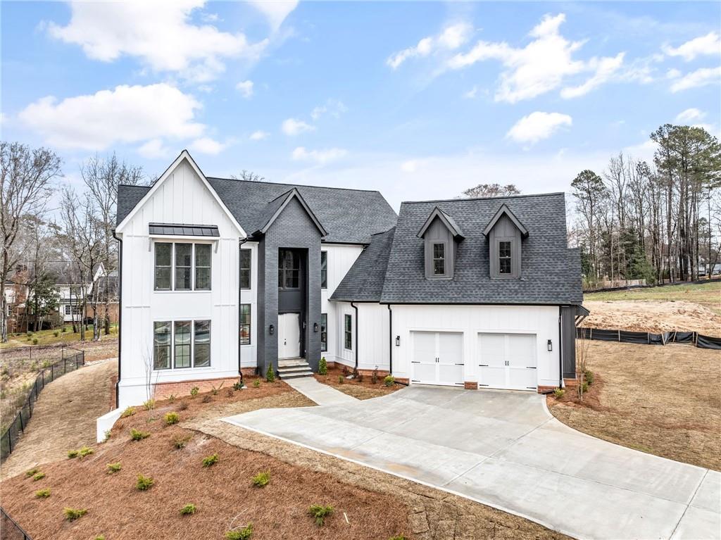 Welcome to this exquisite new construction home, situated in the esteemed Town Farms community of Peachtree Corners. With meticulous attention to detail and impeccable craftsmanship, this 5-bedroom, 4-bathroom residence embodies luxury living at its finest, boasting contemporary fixtures, breathtaking finishes, and an enviable location. Designed to seamlessly blend indoor and outdoor living, this home is a haven for entertainers. The expansive layout features a grand 2-story foyer, a sophisticated office, a formal dining room, a chef's kitchen, and a spacious family room with a sliding door leading to the covered outdoor porch. Convenience meets tranquility with the owner's suite located on the main level, offering a peaceful sanctuary complete with a generous walk-in closet and a spa-like en-suite bathroom featuring double vanities, a soaking tub, and an opulently tiled shower. The chef's kitchen is a culinary delight, boasting high-end appliances, custom cabinetry, elegant quartz countertops, a walk-in pantry, and a substantial center island. Upstairs, three additional secondary bedrooms await, each with its own walk-in closet. One bedroom features its own en-suite bathroom, while the remaining two share a jack-and-jill bathroom. Outside, the private backyard is meticulously landscaped and features a covered outdoor porch with a fireplace, providing a cozy retreat for outdoor gatherings. This prime location offers unparalleled convenience, with proximity to the Atlanta Athletic Club, the Forum, Dunwoody Village, Dunwoody Country Club, and Peachtree Corners Town Center. Don't miss the chance to call this elegant residence your own and experience the epitome of upscale living in Peachtree Corners.