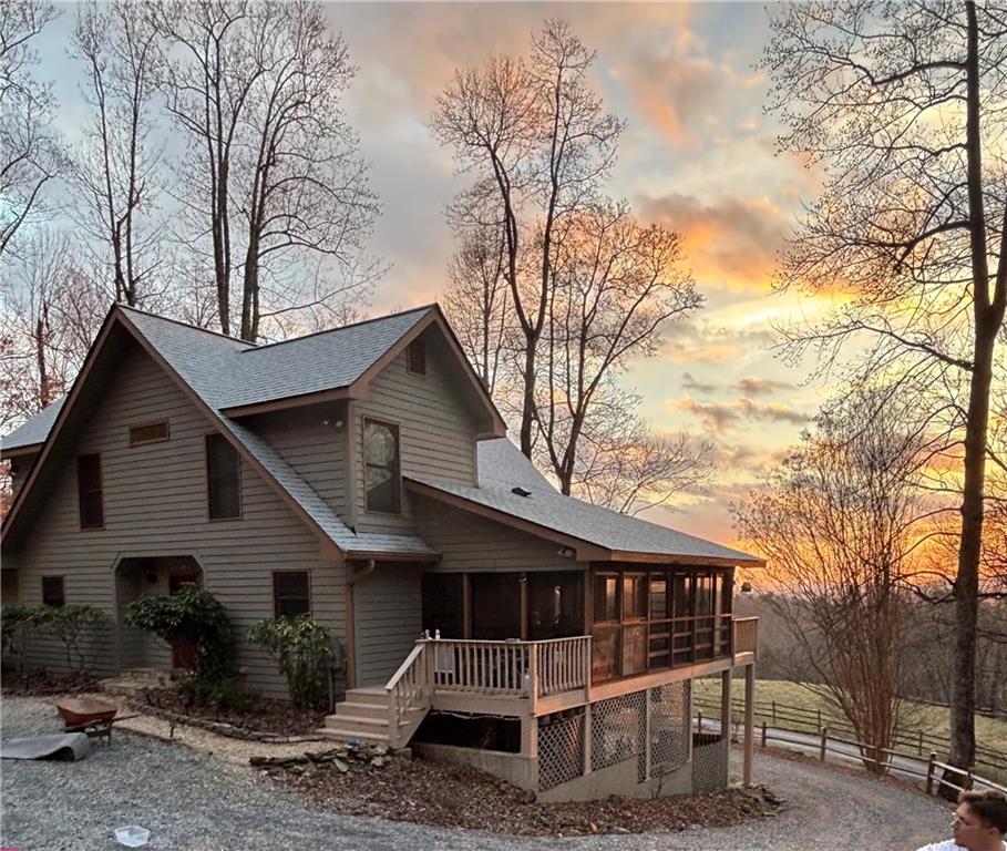 Welcome to 233 Soquili Trail in the desirable Hickory Cove community of Jasper. Nestled on 2.46 private acres, this immaculate home offers unbelievable long-range mountain views and breathtaking sunsets that define North Georgia living.
This multi-level, open-concept home with upper-level bedrooms and bonus space features 3 bedrooms plus an office (easily converted into a 4th bedroom) and 3.5 bathrooms. The finished terrace level is a complete in-law or teen suite with its own private entry, ideal for multi-generational living, extended guests, or private rental space.
Step through the beautiful open foyer and be greeted immediately by mountain views, creating a dramatic and inviting first impression. The heart of the home is the open-concept family room, anchored by a stacked-stone wood-burning fireplace, which flows seamlessly into the family dining area and the gourmet kitchen. The kitchen features custom cabinetry, granite countertops, a walk-in pantry, stainless steel appliances, ample prep space, and a large breakfast bar, perfect for both entertaining and everyday living. A spacious laundry room adds functional convenience. The primary suite is a true retreat, complete with a gas fireplace and expansive windows framing the mountain views.
Outdoor living is exceptional, with a spacious screened-in porch perfect for year-round enjoyment and a large deck overlooking the mountains, providing multiple ways to relax and entertain while enjoying the natural surroundings.