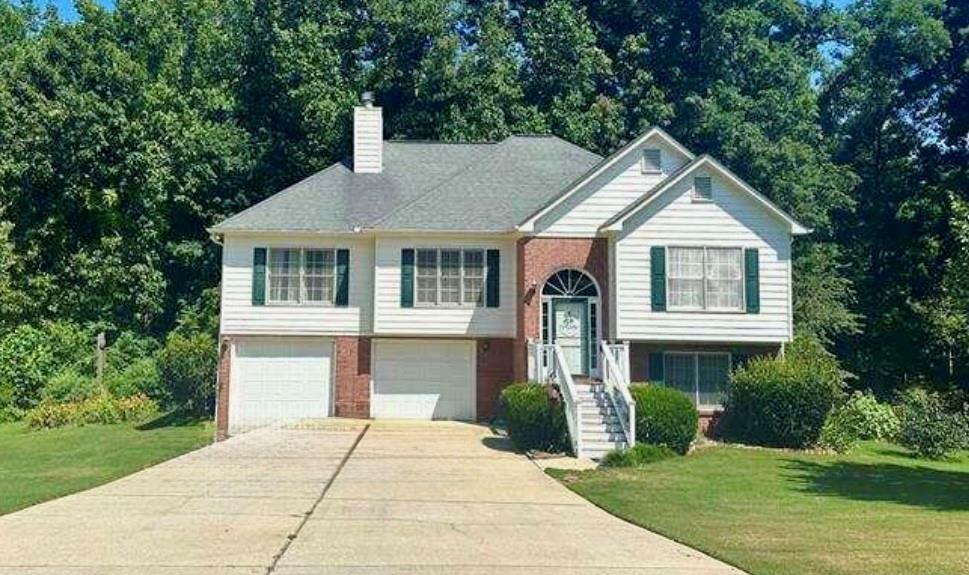 Welcome to 284 Legend Creek Lane in Douglasville-Located in Beautiful Paulding County! Enjoy 2300 sq ft of living space on a generous 1.38-acre lot that includes the neighboring parcel (330 Legend Creek Lane). A creek runs all the way across the property, adding a peaceful, natural touch to your backyard views. This well-designed home features 4 bedrooms and 3 full bathrooms, including a downstairs suite with a bonus room, bedroom, and full bath-ideal for guests, extended family, or a private workspace. The heart of the home features a cozy fireplace, ideal for relaxing evenings! The kitchen offers above-grade appliances, plenty of cabinet space, and a charming window seat overlooking a serene lake view. Recent upgrades include a new water heater and new septic tank and lines, giving you both comfort and confidence. With space to spread out, scenic views, and thoughtful updates, this one truly has it all-inside and out. Schedule your showing today!
