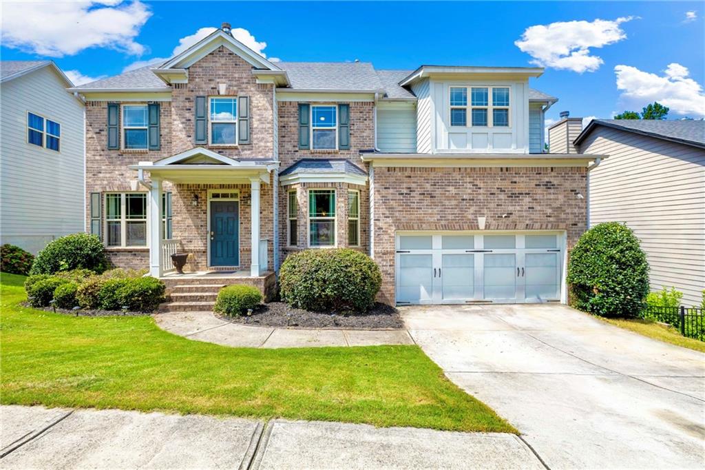 Beautiful brick-front 5-bedroom, 4-bath home in the sought-after Primrose Creek swim/tennis community! Step into a welcoming foyer with formal dining and a versatile study/living room. The kitchen boasts stainless steel appliances, wood cabinetry, granite countertops, and a walk-in pantry. The kitchen opens seamlessly to the breakfast area and spacious family room, featuring a cozy fireplace and a wall of windows filling the space with natural light. The main level also includes a convenient guest suite with a full bath. Upstairs, the oversized master retreat offers a tray ceiling, spa-like bath with his/her vanities, soaking tub, separate shower, and a huge walk-in closet. Three additional large bedrooms, two full baths, and a generous media/loft space complete the upper level. The home also features a full unfinished basement offering endless possibilities for storage, recreation, or future expansion. Enjoy outdoor living with double decks and a large, private fenced backyard perfect for entertaining. This home is ideally located in a top-rated school district, within walking distance to elementary and middle schools, just 3 miles from Lake Lanier’s fishing inlets, and minutes from the growing dining and shopping scene in Downtown Sugar Hill. The perfect house, convenient location, and a private oasis all in one!