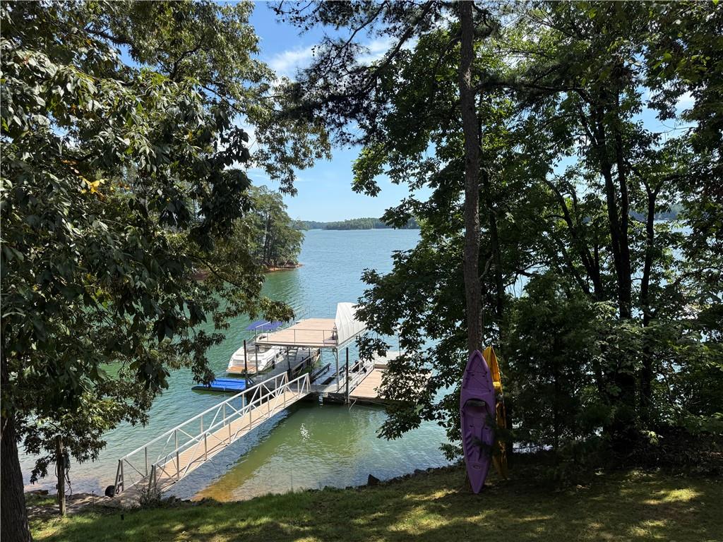Breath taking views of Lake Lanier with gorgeous sunsets. You can sit on one of the decks or on the doc and watch the boats go by and the sun set. This is a large house that has the best bones and main that is waiting for someone to come and and finish it to make it their dream home. All the hard work is done and a buyer can do the inside. You will have a gem on Lake Lanier when it is all done! Lifetime water heater, five fireplaces, new septic in front of home, four newer HVAC units and two have never been used, new duct work, galvanized steel roof, great doc, outside decks, fire pit, and all Pella windows installed in 2018. Property also includes 600 square foot storage room on bottom floor of home.