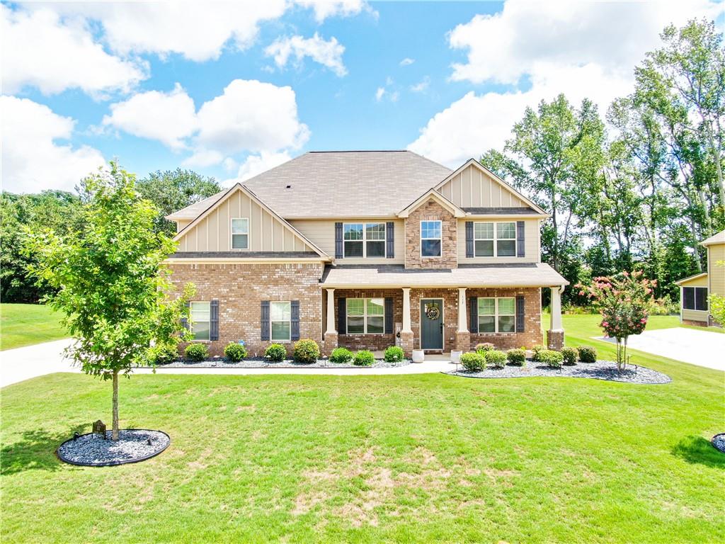 Fall in love with this gorgeous 5 bed, 3 bath Craftsman-style beauty tucked inside the gated Nine Oaks community! Built in 2019 and sitting on a half-acre lot, this home has it all: Open concept living with hardwood floors & coffered ceilings Gourmet kitchen w/ granite countertops, double wall ovens, and oversized island.Guest bedroom + full bath on main Luxe owner's suite w/ soaking tub, separate shower & huge walk-in closet Cozy fireplace + upstairs loft for media room or office. 2-car garage, sprinkler system & sodded lawn Minutes from I-75, Tanger Outlets & more! This one checks all the boxes - space, style, and location. Perfect for growing families or anyone wanting upscale living in a quiet, gated community.