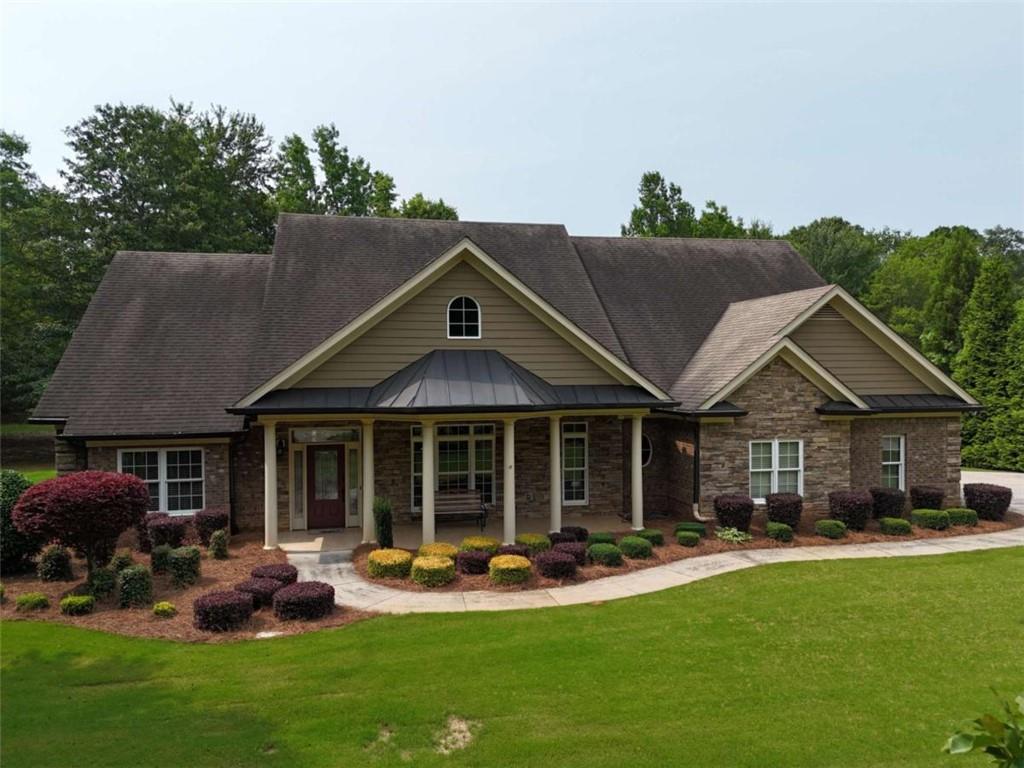 Craftsman style home located on a level 1.57-acre lot offering exceptional privacy while still being convenient to surrounding restaurants and shopping. This well-kept home features three bedrooms plus two and a half baths. Upstairs an additional bonus area is a blank canvas to expand your living space. This home features a spacious primary suite and two secondary bedrooms on the main level. The owner's suite offers an oversized closet and a large walk-in shower with separate tub. Its main living area has a separate dining room and living room that share a double-sided fireplace with an office/flex space all while providing plenty of outdoor light, bringing indoor and outdoor living together. The kitchen is perfect for entertaining with a large island, bar seating, gas cooktop, built in oven with solid surface countertops and walk in pantry. The covered back porch allows for ultimate views and relaxation. An additional detached garage is perfect for any projects or additional storage.