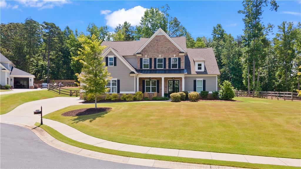 Enjoy lake life living in FORSYTH COUNTY'S sought after, gated, lakefront community of St. Michaels Bay.  HARD TO FIND OWNER'S SUITE AND GUEST BEDROOM WITH PRIVATE BATH ON MAIN!  This home is in immaculate condition with FRESH PAINT ON EXTERIOR AND INTERIOR.  As you enter this 5 bedroom, 4.5 bath, 3 car garage home, you are greeted with natural light and gleaming hardwoods throughout main floor.  The expansive, open floorplan includes owner's suite with tray ceiling on main, luxurious ensuite bath, his and her vanities, large shower, soaking tub, grand closet, guest bedroom on main with private bath, half bath, 2-story entry way, 2-story grand living area, dining room large enough for 8+, chef's kitchen with quartz countertops, stainless steel KitchenAid appliances, oversize island, walk-in pantry, mudroom, laundry room, and 10' CEILINGS WITH 8' DOORS ON MAIN FLOOR.  Upstairs overlooking the downstairs, leads to 3 bedrooms that are all oversize with vaulted ceilings and walk-in closets.  One bedroom has a private bathroom while the other 2 bedrooms include a jack and jill bathroom. The executive level home sits on a quiet, .59 acre, cul-de-sac lot with outstanding pool potential as septic is conveniently located on side of home. The level yard is professionally landscaped, fully fenced with irrigation system.  The top notch amenities in the neighborhood include tennis, pickle ball, playground, pool, clubhouse, fitness, nature trails along Lake Lanier, community marina, social events, and is golf cart friendly.  The school district is for new East Forsyth High School.  Schedule your private tour today and allow extra time to see the lake access and outstanding neighborhood amenities.  Seller is licensed Realtor in state of Georgia.