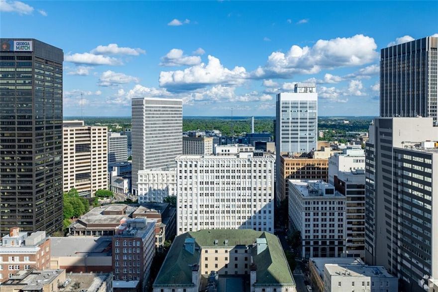 Welcome to the iconic Healey Building - Stunning corner Unit 3B, where timeless architecture meets modern luxury in the heart of Downtown Atlanta! This beautifully updated 1 bedroom, 1.5 bath condo is an exquisite blend of historic character with contemporary comfort. Soaring high ceilings and floor-to-ceiling windows flood the space with natural light while showcasing city views. The modern kitchen flows seamlessly between the living and dining areas - perfect for entertaining or unwinding after a long day. Freshly updated and move in ready, this condo is within one of Atlanta's most treasured historic landmarks, offering residents a blend of classic elegance and vibrant city living. 24 hour concierge service, secure building access, walking distance to Georgia State University, Centennial Park, State Farm Arena, Mercedes-Benz Stadium, also nestled between (2) Marta train stations and a host of restaurants just steps from your front door. Experience the perfect mix of history, style and the convenience of city living - your new home awaits you!