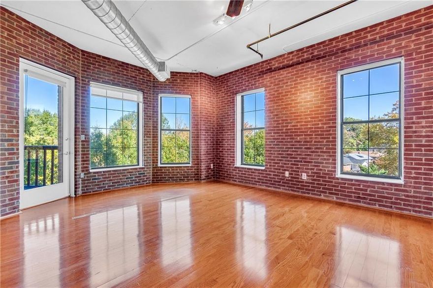 This sun-drenched and inviting loft is the one you have been waiting for! Featuring classic exposed brick walls, beautiful hardwood floors, and relaxing views of both lush trees and Midtown Atlanta—the views are enjoyable from inside or from your spacious private patio. Many things make this loft special, and one is that it offers a true bedroom with floor-to-ceiling walls, a large closet, and an en-suite bathroom. Need more space? The versatile flex area, complete with its own large closet and a custom folding wall for privacy, is perfect for a second bedroom, home office, dining room, or creative studio—tailored to your lifestyle---and right next to a second full bathroom! The kitchen is both stylish and functional as it opens to the living spaces, with wood cabinets that complement the loft’s red brick accents. Your deeded, garage parking spot (and overflow spots are also available for friends and family visiting), means you can leave the car behind and embrace the live-work-play lifestyle at Central Park Place, an exclusive residence with only five units per floor. Step outside to Central Park for tennis, basketball, soccer, or simply relax in the green spaces. Savor music and food festivals in the warmer months, and explore nearby gems like Freedom Park PATH Trail (connecting you to the Beltline), Ponce City Market, Old 4th Ward Park, Piedmont Park, MARTA, and all the excitement Midtown has to offer. The monthly HOA fee covers manicured grounds, clean shared spaces, a fitness center, dry sauna, and essential utilities including gas, water, trash, and termite control. Google Fiber gigabit internet is available in the building as well! The community replaced the roof in 2024, which has already been paid for by current residents. This condo is investor friendly and RENTAL PERMITS ARE CURRENTLY AVAILABLE! This is more than a loft. It’s your gateway to Atlanta’s most dynamic lifestyle, where you can enjoy the best Atlanta has to offer and then come home to a serene home among the treetops.