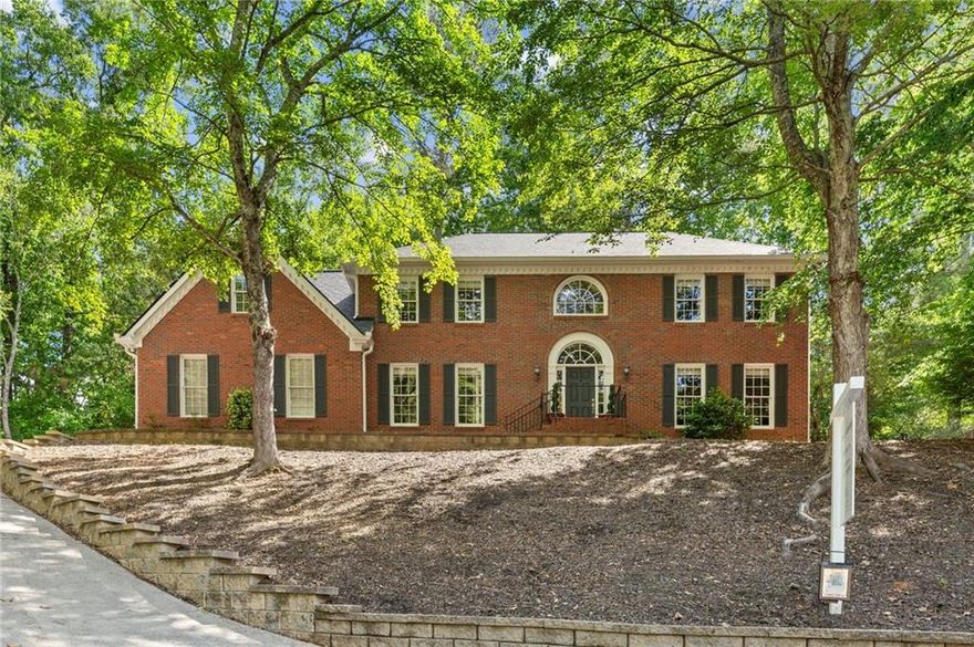 5 Star School District and excellent peaceful location close to all and walkable to Shopping, Dining, Events, Parks, Crabapple + Schools!  This home is nestled on a serene, wooded lot overlooking Hickory Ridge, in coveted Crabapple, and offers a rare combination of privacy, charm, and a prime location. Experience the best of small-town living with every modern convenience in one of the most sought-after top rated school districts. Step inside to discover a home filled with character and one-of-a-kind features. The grand curved stairwell in the front hall immediately sets the tone, offering a warm and elegant welcome. Hardwood floors span both levels of the home. The spacious great room is a true standout, complete with custom built-ins, a cozy fireplace, and a stylish wet bar with adjacent separate office and living room—perfect for entertaining or unwinding after a long day. Just off the hall is a generously sized dining room, ready to host your dinner parties and celebrations. The kitchen has been renovated and blends style with functionality: stainless steel appliances, a striking granite island and countertops perfect for prep work or casual dining, and a sunny breakfast nook with peaceful views of the private backyard. The oversized primary bedroom is a true retreat with plenty of room for a sitting area or workspace, it offers comfort and flexibility. The renovated primary bath features new marble vanity, new designer soaking tub, private shower, linen closet and walk in closet with views of the private back yard. One of the home’s unique features is the screened porch—a tranquil three-season haven that opens to the private, level, pool ready back yard. The full unfinished terrace is stubbed for bath and has partial HVAC and could easily be finished to your needs. New Roof in 2024! This home is up a steeper driveway but the rewards of privacy and the peace and quiet you crave, all while being just moments from shopping, dining, and the energy of Crabapple, Downtown Alpharetta, Downtown Roswell, Avalon and easy access to Interstate 400 make that a plus. Don’t miss this rare opportunity to own a thoughtfully designed, beautiful home in one of Milton’s most beloved neighborhoods. Schedule your private tour today, and come experience what makes this home—and this community—so incredibly special.