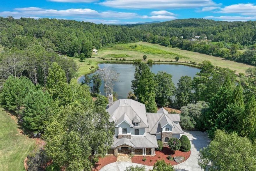 Garden and Gun Dream Home GATED ESTATE on combined 88+ stunning pristine acres with 2 meticulously designed PRIMARY HOMES (6600sf+8,077sf), THIRD RENOVATED GUEST COTTAGE (1800sf approx), separate PRIVATE RECREATION BUILDING/INDOOR GYM, FENCED MAINTAINED PASTURES, and a TROPHY 5-ACRE FISHING LAKE with PRIVATE DOCK. OWNER FINANCE OPTION!  5 Miles from LAKE LANIER.  Enter through the stone-gated entrance, where tree lined paved driveway and professional landscaping lead to the main estates, which are privately centered on the property. The stacked-stone covered porch and circular driveway welcome you, with ample parking for guests & events. The professionally designed interior features light neutral tones and a two-story stone fireplace in the great room. Incredible recently designed butler's pantry and coffee/wine bar.  The main entrance leads to a library/office with custom furniture grade built-in shelving, a spacious dining room, and a completely remodeled chef’s kitchen with Thermador appliance package and sub-zero refrigerator, quartz counters, and new lighting. Expansive windows and balcony french doors offer views of the property and lake. The breakfast room flows into the Great Room with furniture grade built-ins and a flat-screen wiring pkg above the fireplace. The Owner’s Suite is on the main level with terrace access, a custom-designed walk-in closet, and a spa-inspired bath with heated floors. The main level includes a perfectly located guest half bath. Upstairs, find four bedrooms and three full baths, including two ensuites. The loft area is customized with bunk beds and offers easy conversion to traditional massive guest suite potential. The upstairs features a spacious private loft seating area lounge.  The lower finished terrace level features a custom butcher block island bar, second kitchen, family room, billiards area, 2 full baths, guest ensuite bedroom, and a sliding barn door leading to a massive secure storage discrete fresh air concrete bunker—perfect for a wine cellar, safe storage, or shooting range. The creative possibilities are endless.  The lower terrace level opens to a screened porch the entire length of the home, and an infinity custom pool design option overlooking lake. A trex deck and boardwalk lead to the private dock and TROPHY BASS LAKE, designed by Aquatic Environmental Services. The lake is its own ecosystem including investment into Electofish research, 5 feeders, bluegill, crawfish, trout, strain bass, grass carp, as well as a pebble bottom and appropriate aquatic plant life. The property has herds of trophy bucks and deer.  The primary estate home includes water purification, fresh air ventilation, and dehumidification. 2nd MAIN RANCH HOME WITH POOL: 7 total ensuite bedrooms and 7 baths featuring an owner's suite with fireplace, Spa inspired bath with soaking tub, tile shower, heated floors, and his/hers custom closets.Woodgrain tiles and new lighting! POOL! Home generator! GUEST COTTAGE: A 2-bed, 2-bath caretaker or guest suite cottage with private driveway and views, covered front porch and spacious accommodations overlooking large pasture. PRIVATE GYM REC BUILDING: Features a basketball/pickleball court, golf simulator room, kitchen, and two bathrooms with spaces for exterior expansion ideas like tennis or outdoor rec/barn. The land features fenced pastures and a smaller pond ideal for a home site, barn, equestrian facilities, gardens, or homesteading. There is a chicken coop!  What is your vision?  The estate is close to Lake Lanier, private airports, Falcon Training Camp, UGA campus, wineries, vineyards and more. The driveway provides easement to a neighboring 52-acre estate that is also on market with different office, for those interested in a combined 88+ acre compound. Call today for an appointment. We are here to help! Be sure to interact with the virtual tour here!  (2 estates sold as combined or individually, call for details).