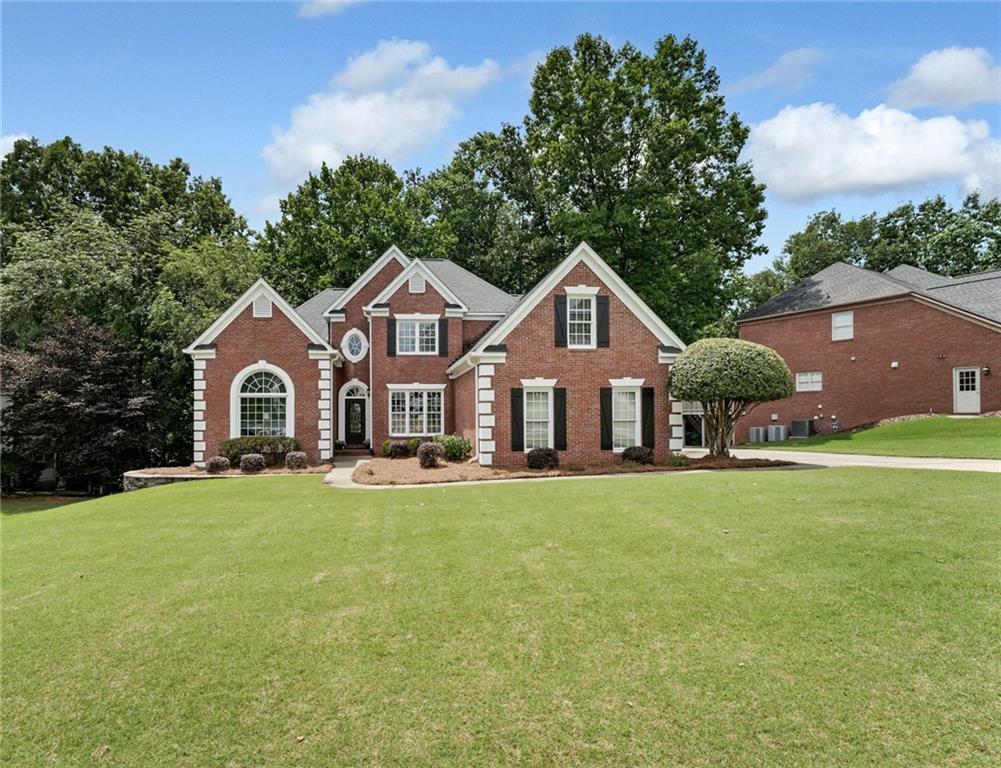 Welcome to this EXCEPTIONAL 5-bedroom, 3.5-bath home with a full, unfinished terrace level—where TIMELESS craftsmanship meets thoughtful modern upgrades. This is more than a home—it’s a lifestyle in OLDE ATLANTA CLUB. Step through the stunning iron front door into a bright, open main level with newly refinished hardwood floors and elegant touches throughout. The sought-after PRIMARY ON MAIN boasts hardwood flooring, deep trey ceilings, and casement windows that fill the space with natural light. Designed for today’s way of living, the home features a spacious private office, cozy fireside family room and a vaulted formal dining room perfect for entertaining. The chef’s kitchen is at the heart of it all, featuring stainless steel appliances, granite countertops, a center island and seamless flow to the breakfast nook and family room—ideal for casual conversations and everyday living. Freshly cased windows across the back of the main floor, flood the interior with sunlight and showcase the beautiful, wooded views. Upstairs, you’ll find hardwood flooring throughout and generously sized secondary bedrooms. All secondary baths have been tastefully updated with modern finishes. The expansive terrace level offers 2,062 sq ft of unfinished space—already stubbed for a bathroom—providing endless opportunities for customization: media room, gym, additional bedrooms, or in-law suite. Enjoy outdoor living on the oversized, recently built deck that offers direct access to the flat driveway. The terraced backyard includes a designated play area, fire pit area and plenty of room to relax or entertain. A 3-CAR side-entry GARAGE includes a car charging outlet. The large, level front yard enhances the home’s curb appeal. With a total of 5,072 sq ft, this home offers abundant space and incredible flexibility. Located in the highly desirable Olde Atlanta Club, residents enjoy resort-style amenities including golf, tennis, clubhouse restaurant, Jr. Olympic pool, kiddie pool, splash pad, playground, pickleball, basketball, and more. All of this in the top-rated Lambert High School district, with Riverwatch Middle and Johns Creek Elementary just minutes away.