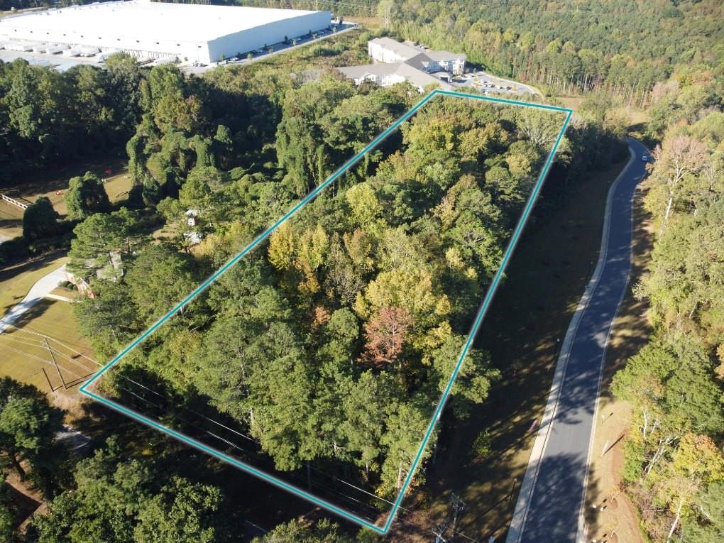 View of property location featuring a heavily wooded area and property boundaries highlighted