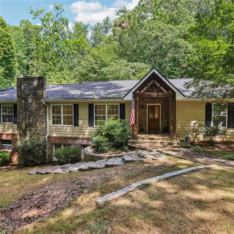 Conveniently located in Buckhead near the Ritz Carlton Residences. Rustic elegance and privacy await you and your family! This amazing home is nestled on .5+ acres! You will love living here! Enter this beautiful private residence through the spacious living room featuring beautiful hardwood flooring, recessed lighting, and a cozy fireplace to snuggle up to on chilly evenings. The eat-in kitchen is fabulous, with features such as a breakfast bar, granite countertops, and stainless steel appliances, including double ovens and a gas cooktop! The chef in the family will be truly delighted! You can access your spacious back deck overlooking the beautiful private park-like grounds through French doors! The convenient and private main-level primary ensuite features a walk-in closet, double sinks, a wonderful soaking tub, and a walk-in shower. Two additional secondary bedrooms on the main level share a jack-and-jill bathroom. The full terrace level with gorgeous slate flooring features a huge family room with a fireplace, two additional secondary bedrooms, and a laundry room. Live in the popular and super convenient Brookhaven! Filled with the best restaurants, shopping, and schools around! You do not want to miss this one! Come and see!