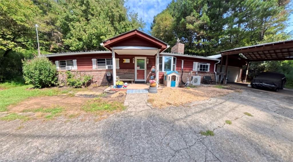 Motivated sellers! Please note no showings until the property is under contract due to family circumstances, unless approved by the sellers. Welcome to this charming 3 bedrooms, 2 bathroom home nestled in a peaceful country setting just minutes from downtown Ellijay, apple orchards, dining, and shopping. Set on 1.84 acres, the property features a wraparound driveway, a covered parking awning, and a garage with an additional storage room- perfect for vehicles, tools, or hobbies. Inside, the home offers a warm cottage-style with timeless wood accents. A separate den or family room provides versatile living space for entertaining, working, or relaxing. Enjoy the outdoors from the large screened in back porch, overlooking a fenced backyard ideal for pets, play, or gardening. This property blends comfort, character, and convenience, offering true country living close to everything Ellijay has to offer.