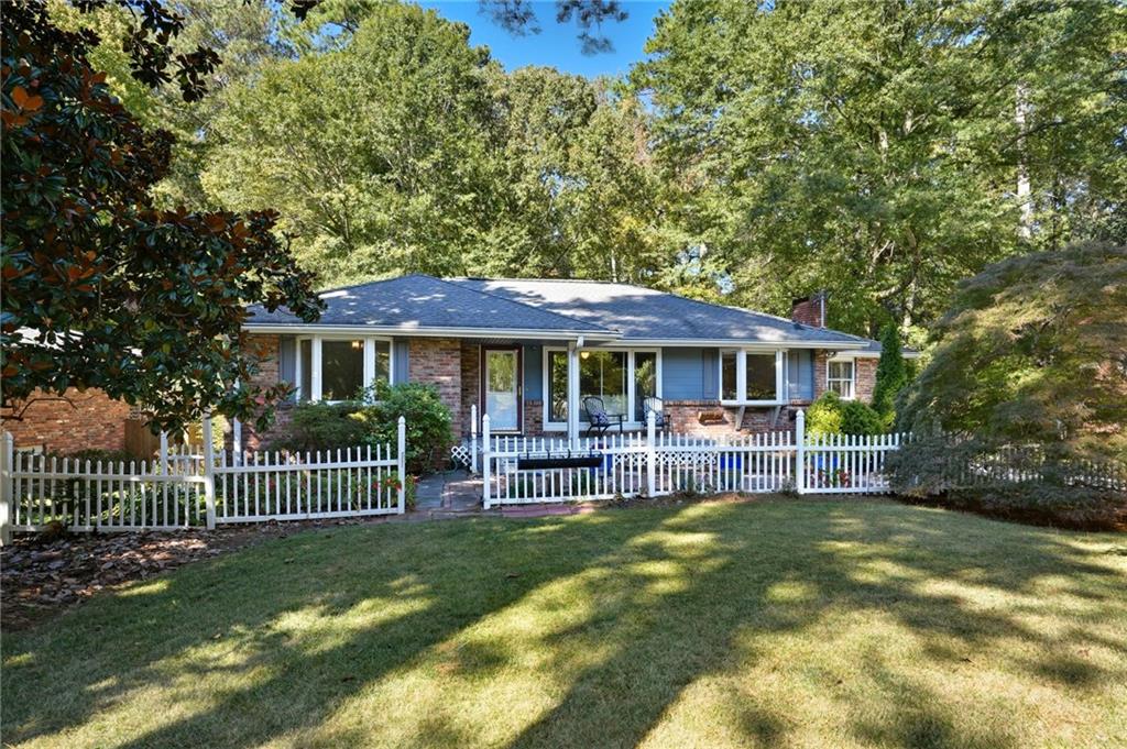 Set on a rare one-acre lot in Decatur, 2702 Pangborn offers privacy, space, and a sense of retreat that feels miles away from the city. Lovingly maintained by the same owners for 25 years, this charming home features a spacious kitchen perfect for avid cooks, multiple living areas, and plenty of room to spread out. The dining room overlooks wooded land, creating a peaceful, treehouse-like view. On the main floor, you’ll find three comfortable bedrooms, including a half bath in the primary (with room to expand) + a full hall bath. Downstairs, the terrace level offers even more versatility with a cozy den and fireplace, a large craft or playroom, and two additional rooms that can flex as bedrooms, home offices, or studios. You’ll also find a full bath, a spacious laundry room, and a generous storage area. With a fully fenced front yard and a welcoming community, this home blends quiet privacy with all the convenience of intown living. A truly special property with room for everyone to live, create, and relax.