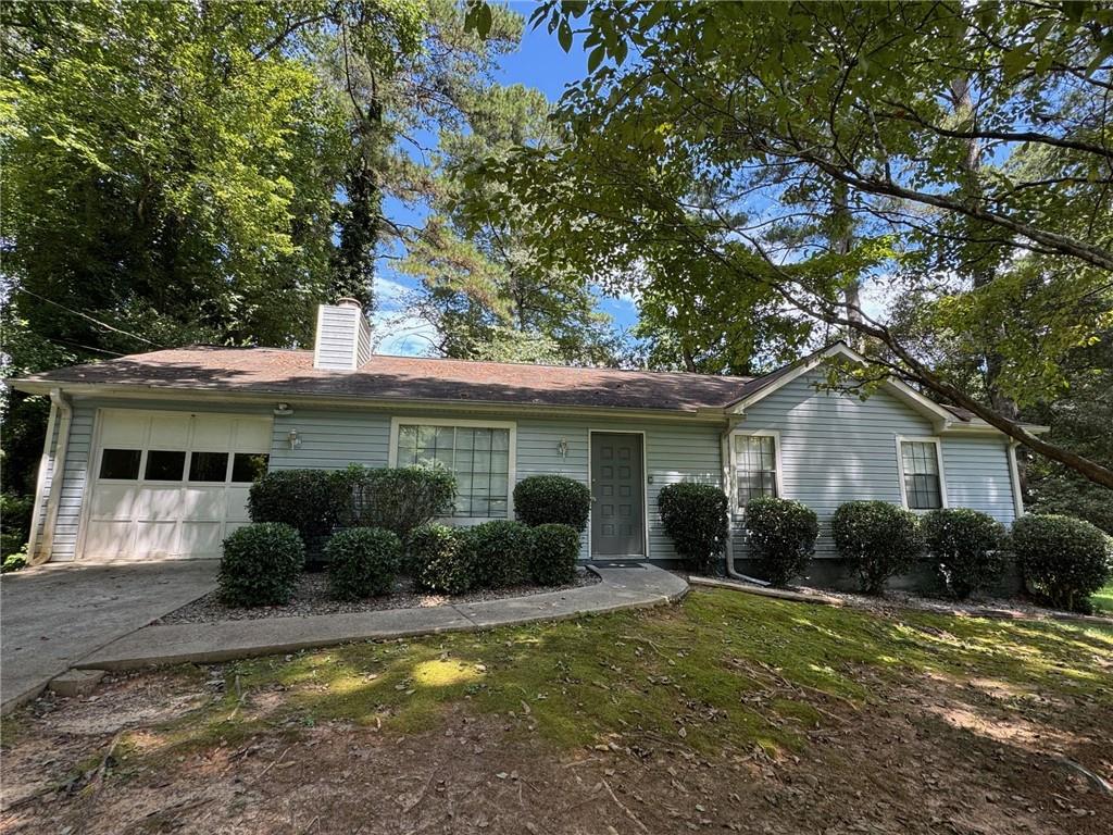 Welcome to this beautifully updated 3-bedroom, 2-bath ranch in a quiet Lilburn neighborhood. Enjoy the fresh paint, natural light, and soaring cathedral ceilings that create a bright, open feel. The cozy masonry fireplace adds warmth and character, while the spacious half-acre lot offers endless outdoor potential. With an attached garage, parking and storage are a breeze. Conveniently located near parks, shopping, and top-rated Brookwood schools, this home combines comfort, convenience, and charm. First month free with a 1.5 year lease. Short term lease options. A must see!