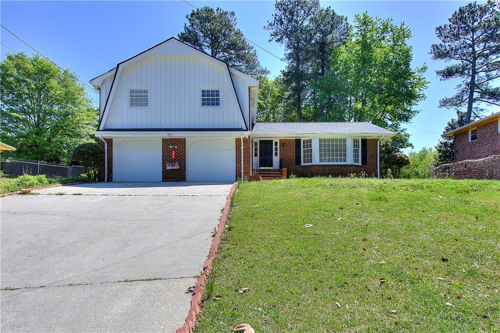 Welcome to this beautiful, 4 Bedroom home located in bustling Stone Mountain, GA. This home is sure to delight. It is spacious inside and out. It sits on an expansive lot with plenty of front and back yard space, privacy, and even a vegetable garden. The bedrooms are generously-sized and there are gleaming, low-maintenance hardwood floors throughout the home. The floorplan is functional and welcoming. The kitchen has ample cabinet space and an eat-in area, perfect for enjoying your morning cup of coffee or tea. Just bring your finishing touches and make this great house, your new home. It is completely move-in ready with newly installed roof, HVAC, and water heater, plus fresh interior and exterior paint. Conveniently located near Milan Park with swimming pools, trails (The path) for bike and close to Clarkston, this home is centered near great shopping, entertainment, and so much more. Don't wait. Schedule your exclusive showing today!