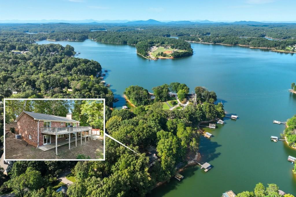 This beautifully updated, cozy lake cottage with stunning lake views from almost every room, deep water, a 32x32 twin slip dock permit - allowing for an easy upgrade, and a grandfathered 100' sea wall with concrete patio, combine to offer a peaceful escape you'll look forward to every day. Situated on a generous .8 acre lot, (2 1/2 platted lots), with Lot 7 remaining undeveloped and a newly installed wood fence in the front yard, this all-brick ranch with finished basement, features 4 bedrooms, 3 full baths, and 2 brick fireplaces. This home offers both a main level and terrace level primary suite, with the terrace level suite featuring a fireplace and custom closet. There is an additional room that can also function as a 5th bedroom, a game room, office space, or additional family room with gorgeous lake views! Outside, you'll enjoy the extensive deck off the family room, and a lower covered patio. Convenient to 985, just minutes from the charming downtown Gainesville Square with shopping, dining, and the hospital, you'll enjoy easy access to these amenities, all while enjoying all this property has to offer. A Radon Inspection/Summary was done in June and is on file. Buyers have loved this home and are selling due to a job relocation. Can be sold furnished with few exceptions. Whether you're seeking a weekend getaway or a year-round oasis, this cottage delivers privacy, unmatched views, and the ultimate lakeside lifestyle. Don't miss your chance to own this special retreat-schedule your private tour today and experience the warmth and beauty for yourself.
