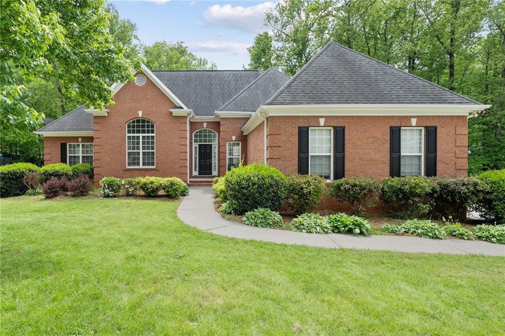 Welcome to this stunning brick home located in the desirable Beringer Point neighborhood in Hoschton, GA! This gorgeous property features an open ranch floor plan that's perfect for entertaining guests or relaxing with family.
As you step inside, you'll immediately notice the high ceilings that create a spacious and airy feel throughout the home. The sitting room with gas log fireplace is the perfect place to cozy up with a book for a relaxing evening.
The oversized master bedroom on the main level offers a peaceful retreat, while the large secondary bedrooms provide plenty of space for family members or guests. With four bedrooms and three and a half baths, this home has ample space to accommodate any lifestyle.
The full-size partially finished basement is a great bonus space, offering endless possibilities for entertainment or storage. With a separate entrance driveway to the basement, this space could even be used as an in-law suite, offering privacy and independence.
The large private backyard is a true oasis, providing ample space for outdoor entertaining or relaxation.
Located near the heart of Hoschton, this home boasts an amazing location with easy access to shopping, dining, and entertainment options. Don't miss out on the opportunity to make this beautiful property your new home!