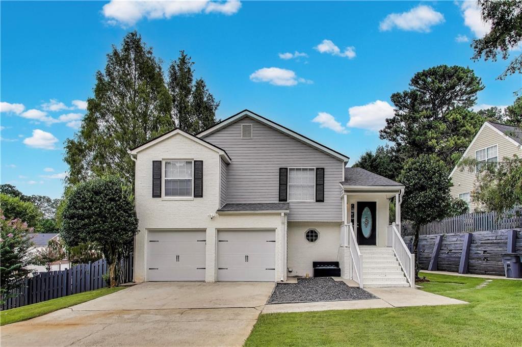 This stunning home was completely renovated in 2022 from the floor up, offering the perfect blend of modern upgrades and spacious comfort. NO HOA. Featuring 5 bedrooms and 3 full bathrooms with over 2,200 square feet of living space, this property is ideal for a large family or anyone who enjoys frequent gatherings. Sitting on a private corner lot with 0.22 acres, the home offers both privacy and convenience, with a fenced backyard, a large front yard, and a two car garage complete with new garage doors and a huge driveway. The roof and A/C are only three years old, giving you peace of mind with these major updates already taken care of. Inside, the split level layout provides great versatility. The downstairs features two generous sized bedrooms, a full bath, and plenty of space that could easily be converted into a second kitchen, making it a great option for renting out or accommodating extended family. Upstairs, the open concept design connects the kitchen, dining, and living areas seamlessly, highlighted by real hardwood flooring and modern light fixtures throughout. The kitchen has been updated to perfection with quartz countertops, recessed lighting, and sparkling modern fixtures, paired beautifully with high end stainless steel appliances including a convection oven and range hood. The master suite is a true retreat, featuring an immense walk in closet and a spa like bathroom with quartz countertops, a stunning ceramic shower with glass doors, and a thoughtfully designed layout for comfort and style. Additional bedrooms are spacious, with clean carpet and plenty of natural light, while the hallway bathroom has been fully remodeled with elegant white tile and glass shower doors. Step outside to enjoy the back deck overlooking the private, fully fenced backyard, perfect for relaxing evenings or entertaining guests. With fresh paint inside and out, this home feels brand new and ready to move in. Located just two minutes away from John R. Lewis Memorial Park, Tom E. Morris Sports Complex, and the Porsche Center, and within walking distance to all your favorite stores, restaurants, and salons, the location is unbeatable. The area is rapidly growing with new construction and development, making this not only a beautiful home but also a smart investment. Don’t miss your chance to own this exceptional property in such a blooming historic community. Schedule your tour today and see why this home is truly special.