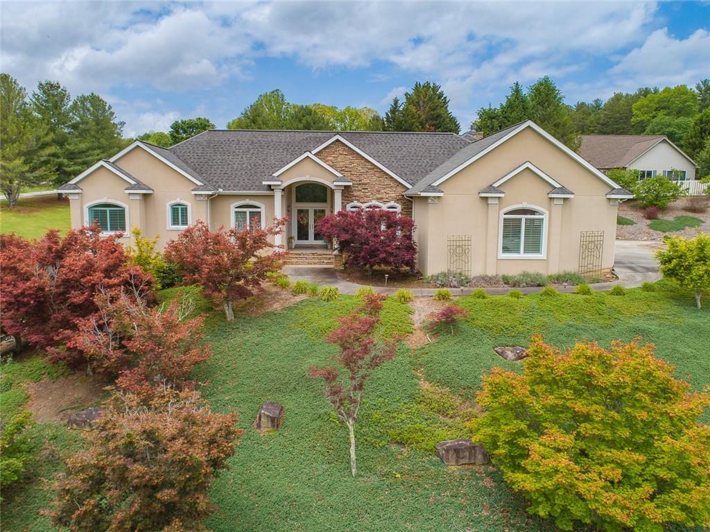 Welcome to your new mountain retreat in a peaceful, mature neighborhood. This elegant, well-maintained 5 bedroom ranch offers an open floorplan featuring an upgraded gourmet kitchen with walk-in pantry, views to the family room, separate sitting area with french doors to covered patio, home office, formal dining room, master on main with sitting area and exterior door to patio, large ensuite, and two additional bedrooms on main. Each room is filled with natural light and amazing views. The full, finished basement is a complete separate living area. It encompasses 2 bedrooms, 1 full bath, ample storage, work shop with garage door, kitchen, large family room with french doors opening to patio. This traditional, meticulous home host beautiful millwork details, tray and vaulted ceilings, gleaming hardwood flooring, plush carpeting in secondary bedrooms, quartz countertops, and many more stunning features. The 1.6 acres are manicured with mature scrubs, trees and garden(s). Escape to your private retreat! This home is an absolute paradise.