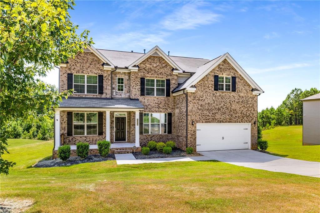 Welcome to your dream home — where space, comfort, and serene views come together beautifully! This impressive 4-bedroom, 3-bathroom residence offers an open-concept design filled with natural light and thoughtfully designed living areas. You'll love the convenience of a full bedroom and bathroom on the main level — perfect for guests or multigenerational living. The heart of the home is the breathtaking two-story living room with soaring ceilings, a cozy fireplace, and a dramatic wall of windows that provide a peaceful, private view of the backyard and surrounding nature — no rear neighbors, just tranquil beauty. Overlooked by a striking catwalk, this space seamlessly connects to the chef’s kitchen, which features granite countertops, a spacious island, stainless steel appliances, double ovens, a built-in microwave, and a dishwasher — ideal for everyday living and entertaining. Upstairs, unwind in the expansive primary suite, complete with a luxurious en-suite bath and an oversized walk-in closet. Two additional bedrooms offer plenty of space for family, guests, or even a home office setup. Step outside and enjoy a generous backyard with a deck that’s perfect for summer barbecues or peaceful morning coffee. Plus, the large unfinished basement offers endless possibilities — create a home gym, media room, or extra living space tailored to your needs.This home truly has it all — thoughtful layout, stylish finishes, and space to grow. Don’t miss your opportunity to make it yours!