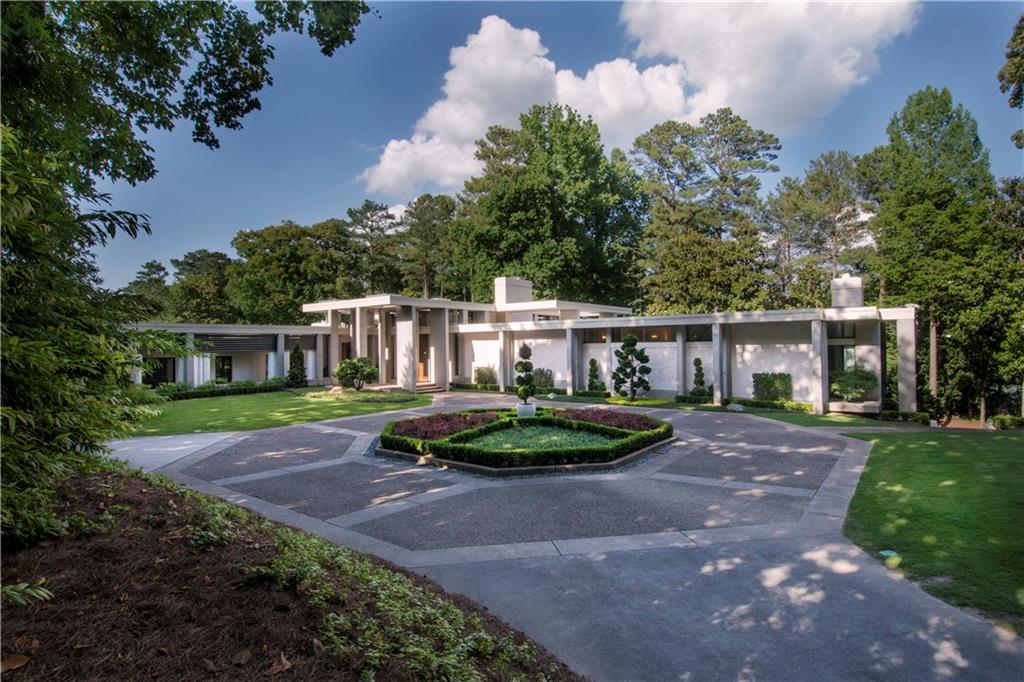 Spectacular architecture and scale by noted Laguna Beach architect Fred Briggs. Located in the hottest neighborhood in Buckhead. Design centric with perfect mix of transitional elements including oak plank flooring from France mixed with stone floors. Large expanses of glass that open to patios. The master bedroom wing has fireplace & bath with marble & mosaic tile & double walk in closets. The oversized kitchen has SubZero, Wolf appliances, and wine cellar. Enjoy the full gym with spa bath next to the heated pool/spa. Crestron, security and a whole house generator.