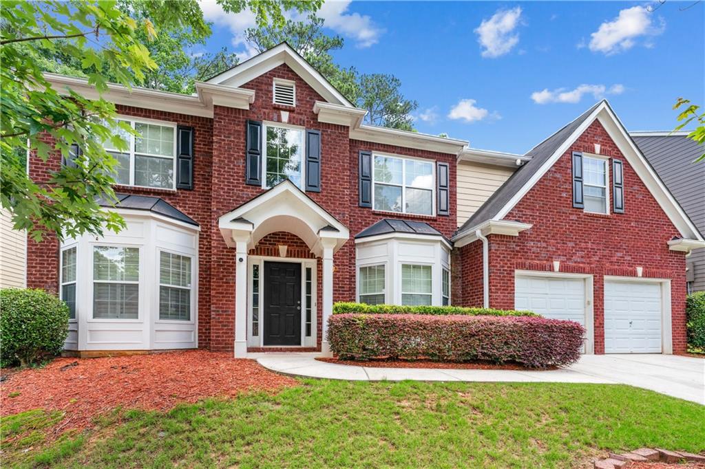 Welcome to the crown jewel of Saddlebrook—where elegance, space, and craftsmanship come together in the largest and most refined home in the neighborhood. Spanning nearly 3,500 sq ft, this exquisitely upgraded residence offers luxurious living at every turn. Step into a grand 2-story foyer adorned with imported Canadian Red Oak hardwoods, finished onsite for a rich, timeless look. Custom iron stair spindles, hand-carved wood accents, and updated chandeliers add a bespoke touch throughout. Plantation shutters provide both style and privacy, while the newly added front portico offers a warm and welcoming entry. The gourmet kitchen features granite countertops, rich cherry cabinetry, stainless steel appliances, and opens seamlessly to a spacious great room—perfect for entertaining. Formal living and dining rooms, a private office, a half bath, and a laundry room complete the main level. Upstairs, the oversized primary suite is a true retreat, featuring a large sitting area ideal for a library or office, a spa-like bath with a soaking tub and separate shower, and an expansive walk-in closet (with easy potential to create a fifth bedroom). Three additional bright bedrooms and a full bath offer space for all. Outside, enjoy a beautifully landscaped, low-maintenance yard with a concrete patio for gatherings. Major system upgrades include a new HVAC system, a new furnace, a new water heater, and more, providing peace of mind for years to come. Located just minutes from Dobbins Air Reserve Base, Truist Park, Cobb Galleria, Hartsfield-Jackson Airport, and downtown Atlanta, this home blends luxury, convenience, and character in one unforgettable package. Schedule your private showing today!