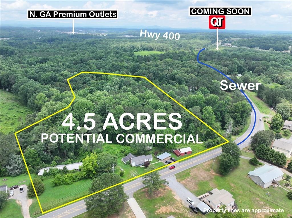 Prime opportunity to own 4.5 acres of highly visible potential commercial land featuring an impressive 463 feet of road frontage. Located just minutes from the North Georgia Premium Outlets, Hwy 400, and the upcoming QT, this property offers outstanding development potential in a rapidly growing area. A 3 bedroom, 1 bathroom home sits on the land and could be renovated for office or rental use. Sewer is nearby, and the county has confirmed it can be connected, making this a strong candidate for future commercial use or investment.
