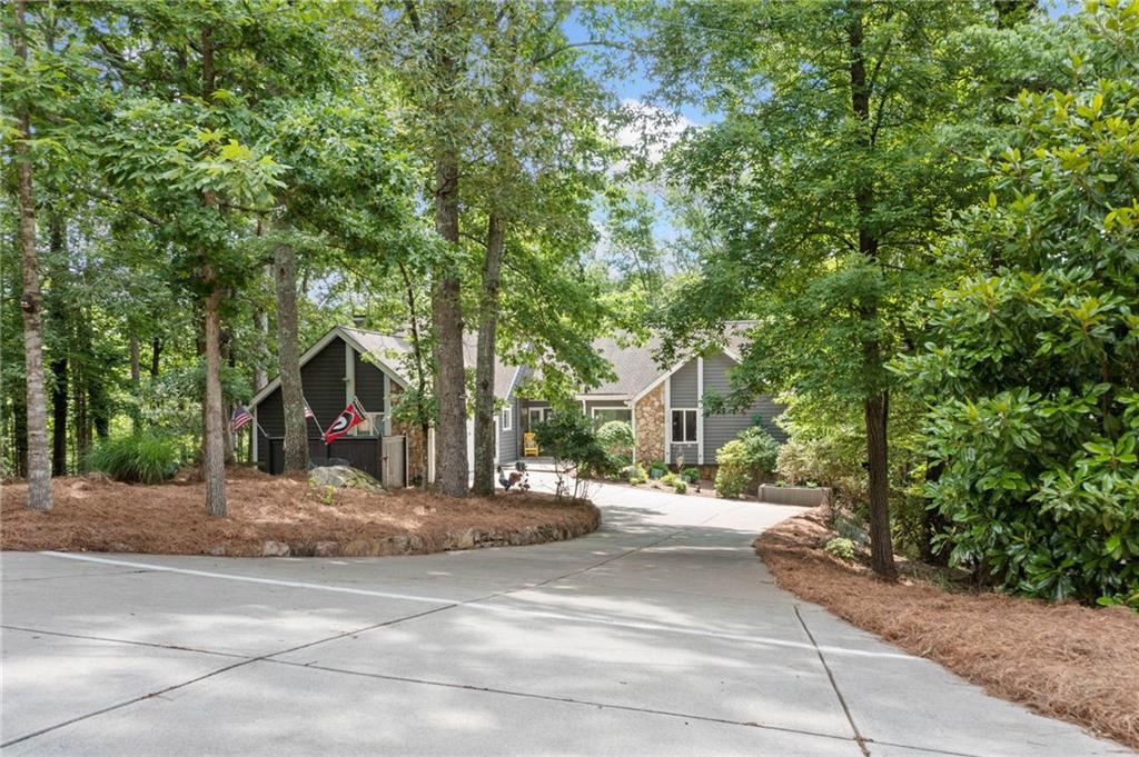 Incredible Fully Renovated Lake Front Home. This Beautiful Ranch Over a Full Finished Walkout Terrace Level Sits a Private Wooded Lot with 157 Feet of Water Frontage on Lake Chickasaw, a Private Lake Inside the Community of Lake Arrowhead. Enjoy a Low Maintenance Landscaped Yard with Easy Walk to the Dock. A Level Driveway Leads to the Home and a Covered Stone Front Poch with Leaded Glass Double Doors Welcomes You Home. Once Inside the Two Story Entry, the Great Room with Vaulted Ceilings and Exposed Beams Draws You In. A Full Wall of Windows Overlooks an Expansive Deck and Lake Views. Stunning Kitchen with Beautiful White Cabinetry Showcases Glass Fronts, Lit from the Inside! Open Concept Dining Area Offers Views to the Kitchen, Great Room and Lake! Well Equiped Laundry Room Provides Additional Pantry Space, Coffee Bar and Beverage Fridge! There is a Dedicated Home Office with Private Half Bath and Full Closet that Would Transition Easily to a Bedroom. This Incredible Home has Two Primary Suites with Private En Suites on the Main! One has Vaulted Ceiling with Exposed Beams and Access to a Private Three Season Room with Outdoor Fireplace! The En Suite Offers a Gorgeous Spa-like Tile Shower, Double Vanity and Luxurious Soaking Tub. The Second Primary Suite is Impressive with Access to Private Three Season Room Overlooking the Lake. The Ensuite Includes A Beautifully Custom Tiled Shower with Seamless Glass Door. The Fabulous Finished Terrace Level Provides a Second Living Area with Rustic Stone Fireplace and Access to a Covered Deck that Runs the Entire Length of the Home! Two Guest Bedrooms are Ideal for Overnight Lake Guests. A Full Bath Ensures Privacy and Convenience for All. The Second Kitchen with Double Ovens is Great for Entertaining and Large Friend and Family Gatherings. A Hobby/Game Room and a Home Gym Offers Plenty of Options for Everyone. There is Also a Large Unfinished Workshop/Game Room and Even More Storage Space. Enjoy Sitting by the Firepit with Beautiful Views or Head Down to the Dock with Deep Water for a Swim or Boat Ride! Come see for Yourself and Start Imagining the Memories to be Made Here. Priced Thousands Below Recent Appraisal. Most of the Furnishings are Included. Please Ask for a Detailed List.