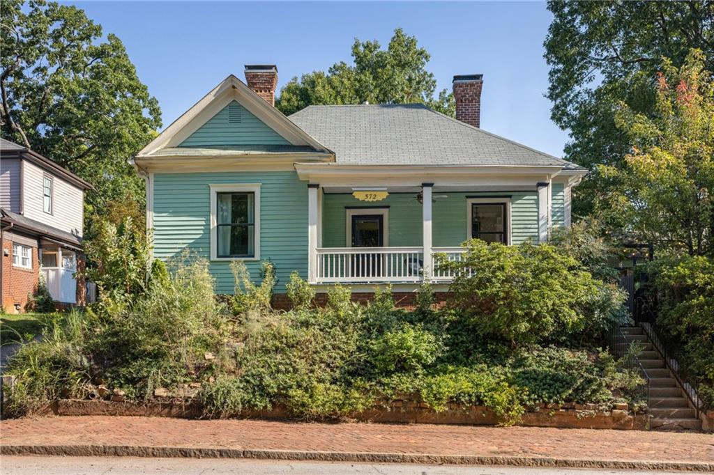 Welcome Home ATL to this 1920’s Grant Park gem, tucked along beloved Sydney Street and just half a block from the park itself. From the moment you step onto the rocking chair front porch overlooking a pollinator garden, you’ll feel the charm this home carries so effortlessly. Inside, sunlight fills every room, highlighting original pine floors, soaring 10-foot ceilings, and three decorative fireplaces that add warmth and character. The kitchen, fully redone in 2022, combines modern updates with timeless appeal, featuring an induction range, butcher block countertops, a pantry, and two-tone cabinetry. Morning light pours in through east-facing windows, creating a peaceful start to the day. Outdoor living shines here, too. A private courtyard with hand-built stone walls is perfect for dinner parties under the stars, while fruiting blueberries, muscadine vines, and a pear tree provide a homegrown touch. Practical updates bring peace of mind, including all new high-efficiency windows and full attic insulation completed in 2019. This is a home where neighbors become friends, where evening walks in Grant Park are part of your daily rhythm, and where thoughtful renovations meet enduring character. More than a place to live, it’s a place to belong, and opportunities like this are rare!