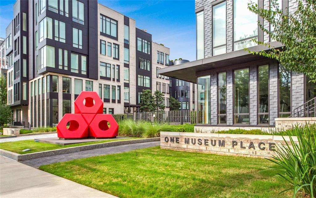 Experience refined luxury in this spectacular residence at One Museum Place, perfectly positioned in the heart of Atlanta’s vibrant cultural corridor. Accessed via private elevator, this single-level residence offers floor-to-ceiling windows with sweeping views of the High Museum, Woodruff Arts Center, and Midtown skyline. The expansive open floor plan is enhanced by soaring 11+ ft ceilings, floating architectural details, and designer finishes throughout. Automated recessed window treatments and Lutron lighting systems create effortless ambiance. The chef’s kitchen is a showstopper, featuring a grand center island, high-gloss lacquered cabinetry, and a full suite of Gaggenau appliances—including dual dishwashers, a wine tower, and a 5-burner gas cooktop—paired with custom fixtures and hardware. The gracious owner’s suite offers a spa-caliber bath with water closet, floating vanities, a soaking tub, and a glass-enclosed double shower, plus two oversized walk-in closets. Secondary bedrooms each enjoy luxe en-suite baths with frameless glass and bespoke tilework. Additional features include a large laundry room with wet sink and cabinetry, a private 3-car garage, and access to resort-style amenities: 24-hour concierge/security, state-of-the-art fitness center, wine tasting room, guest suite, club room, and dog walk. Steps from premier dining, arts venues, and the Atlanta Botanical Garden, this residence offers an unmatched lifestyle in one of Atlanta’s most prestigious addresses. One Museum Place—where art, architecture, and lifestyle converge.